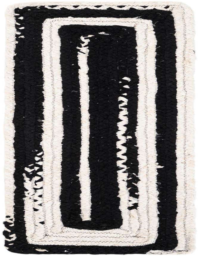 A 1' 2 x 4' 1 black and white braided cotton runner rug with thick vertical stripes, ideal for a table or hallway.