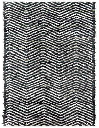 A black and white chevron pattern runner rug, handmade from recycled cotton, with a textured flatweave.