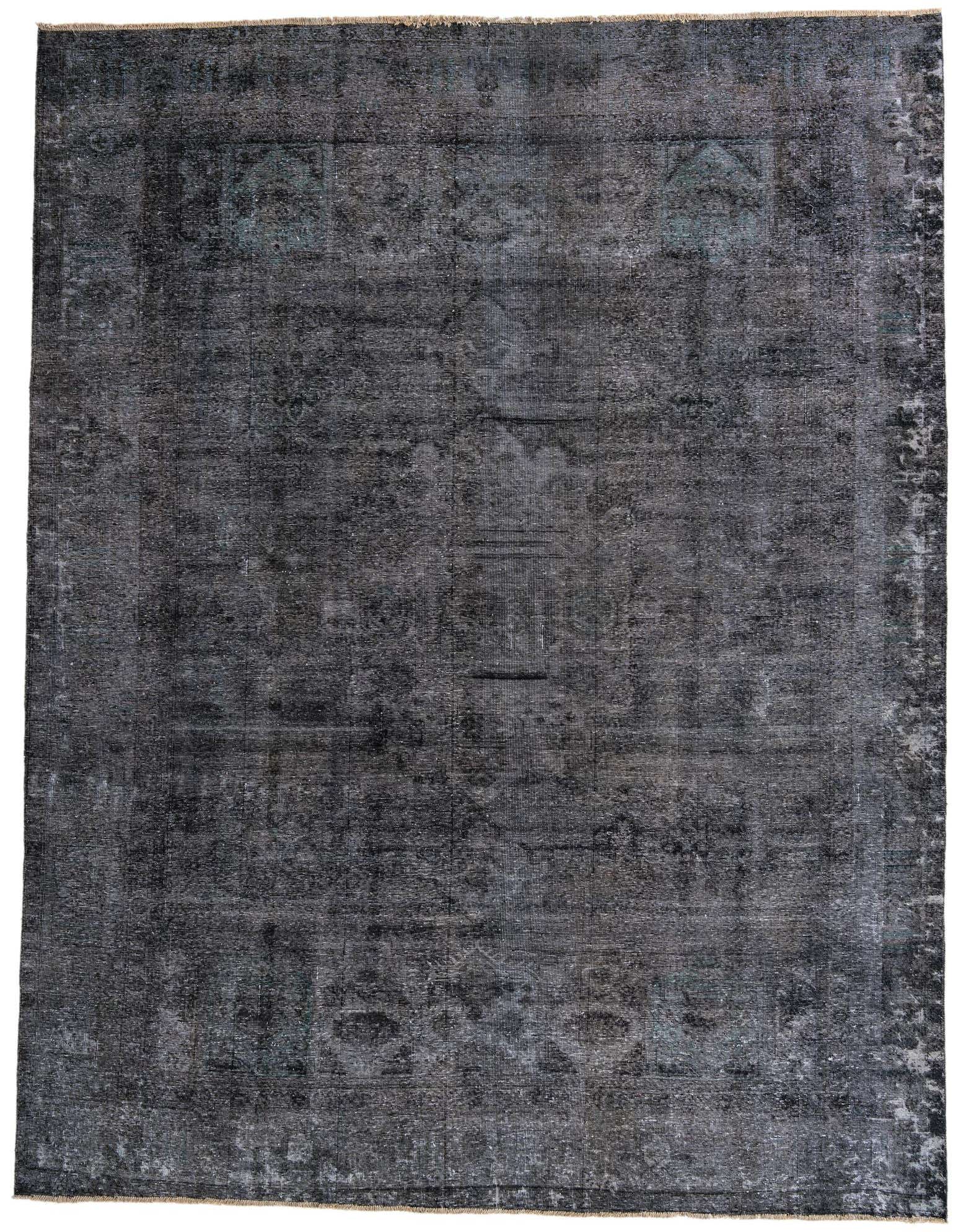 A 9x12 rectangular black and gray vintage Persian wool rug with a faded medallion pattern.