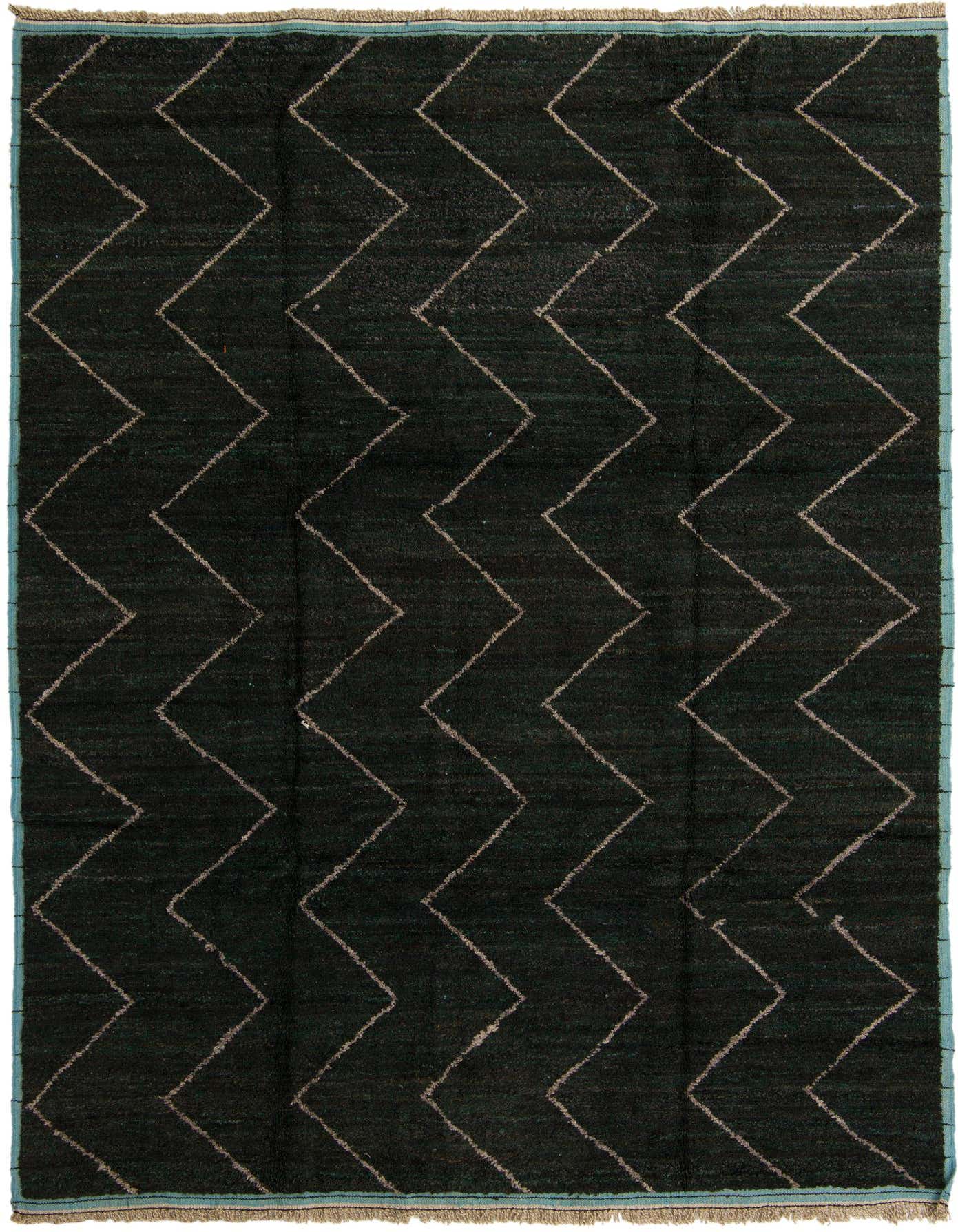 A 9x12 rectangular black wool shag rug with a modern tribal zigzag pattern and a thin green border.