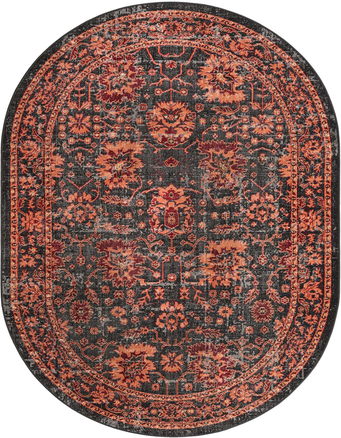 A 6'1" x 9'0" oval black rug with a distressed traditional pattern in shades of orange and red, suitable for a patio.