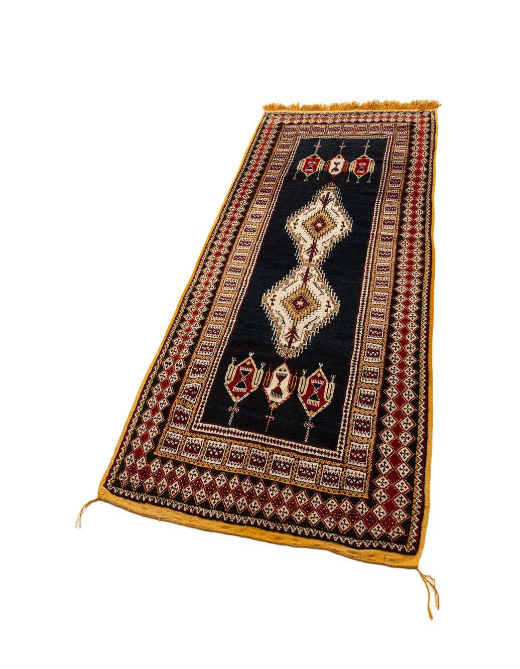 A 5x8 rectangular black Berber rug with intricate red, cream, and gold geometric patterns and fringed ends.