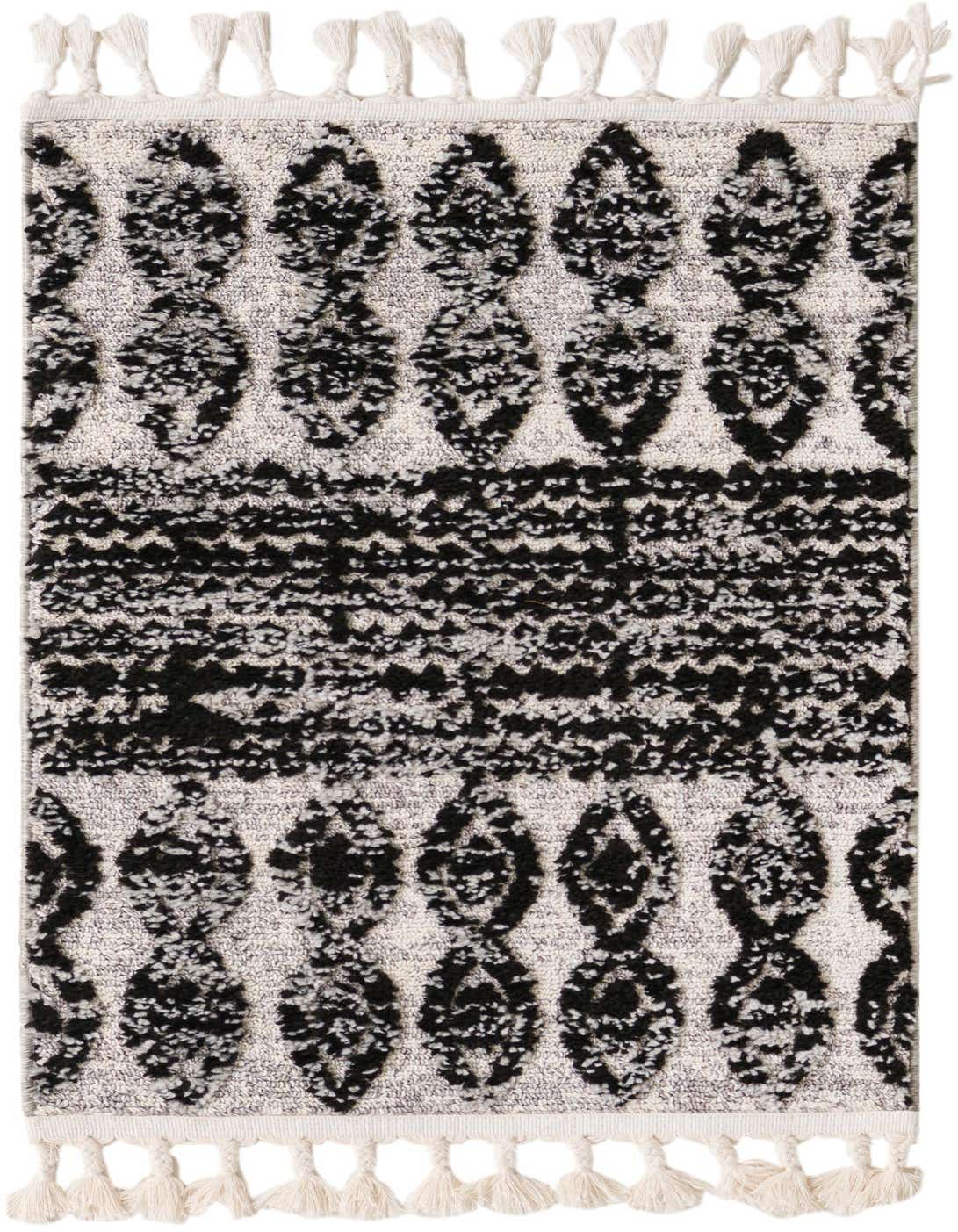 A 2x3 rectangular black and off-white tribal rug with textured pile and decorative tassels on both ends.