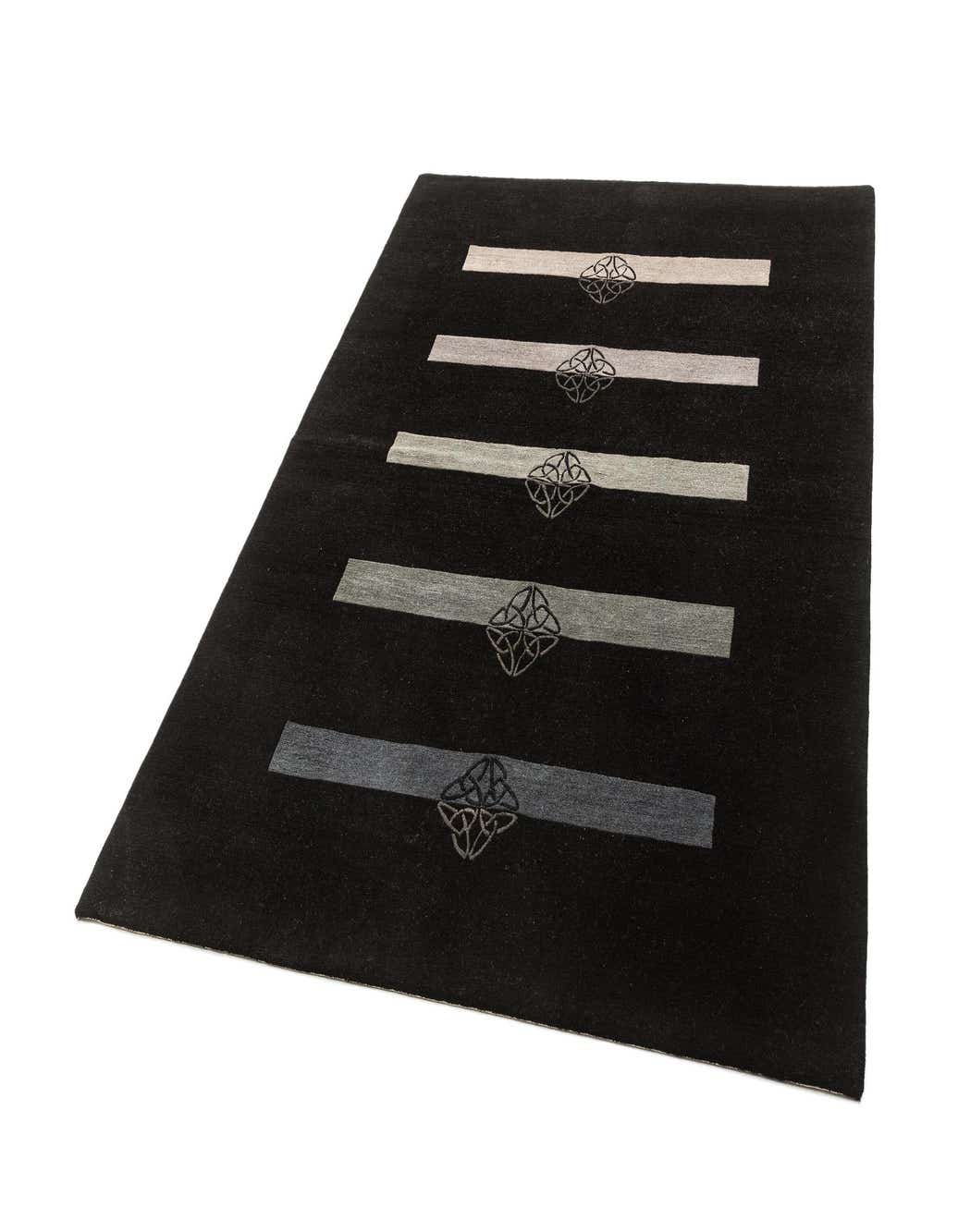 A 5x8 rectangular black wool rug with five horizontal gray stripes, each centered with a Celtic knot design.