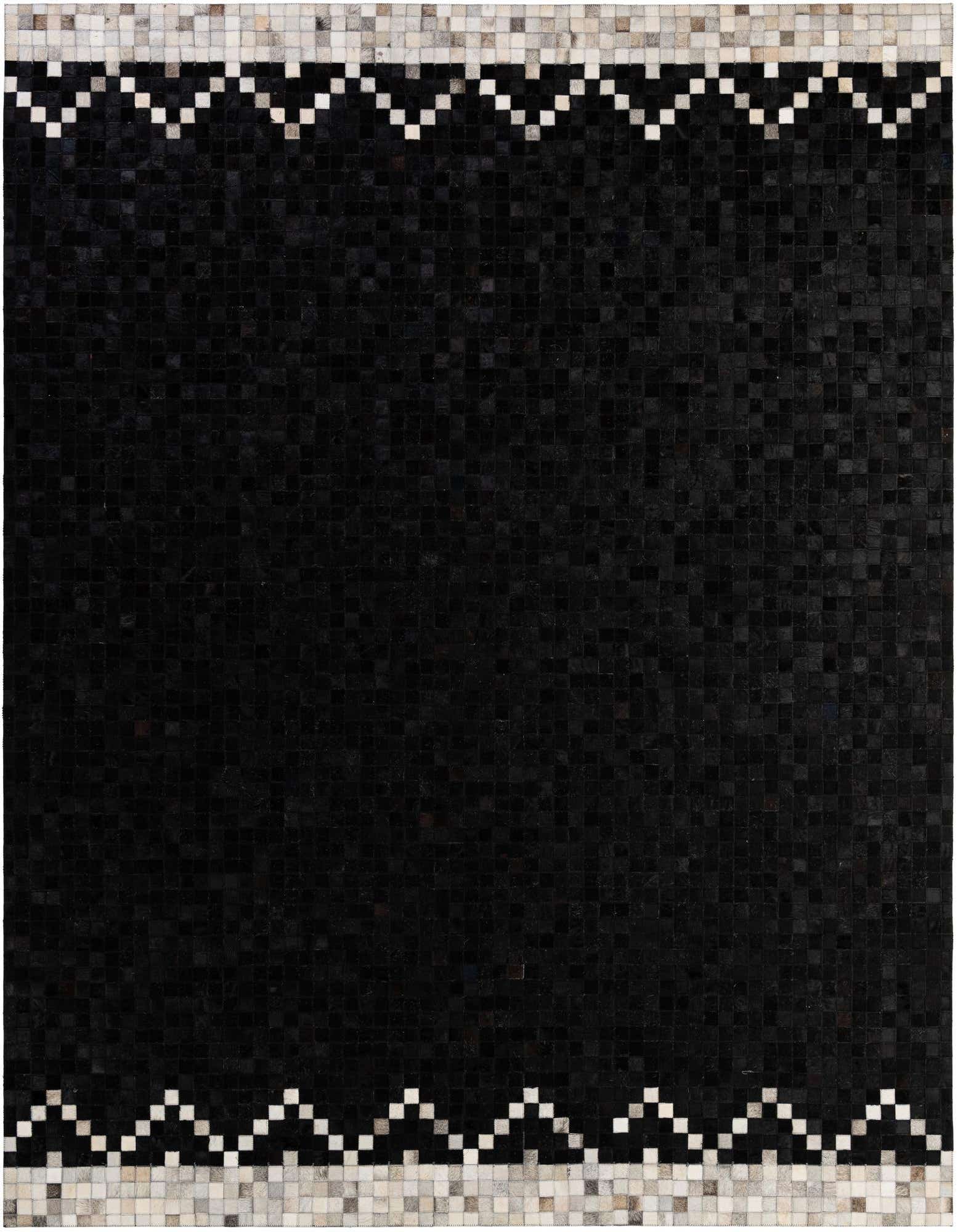 A rectangular 8x10 black cowhide rug with a modern patchwork design and a light grey and white geometric border.