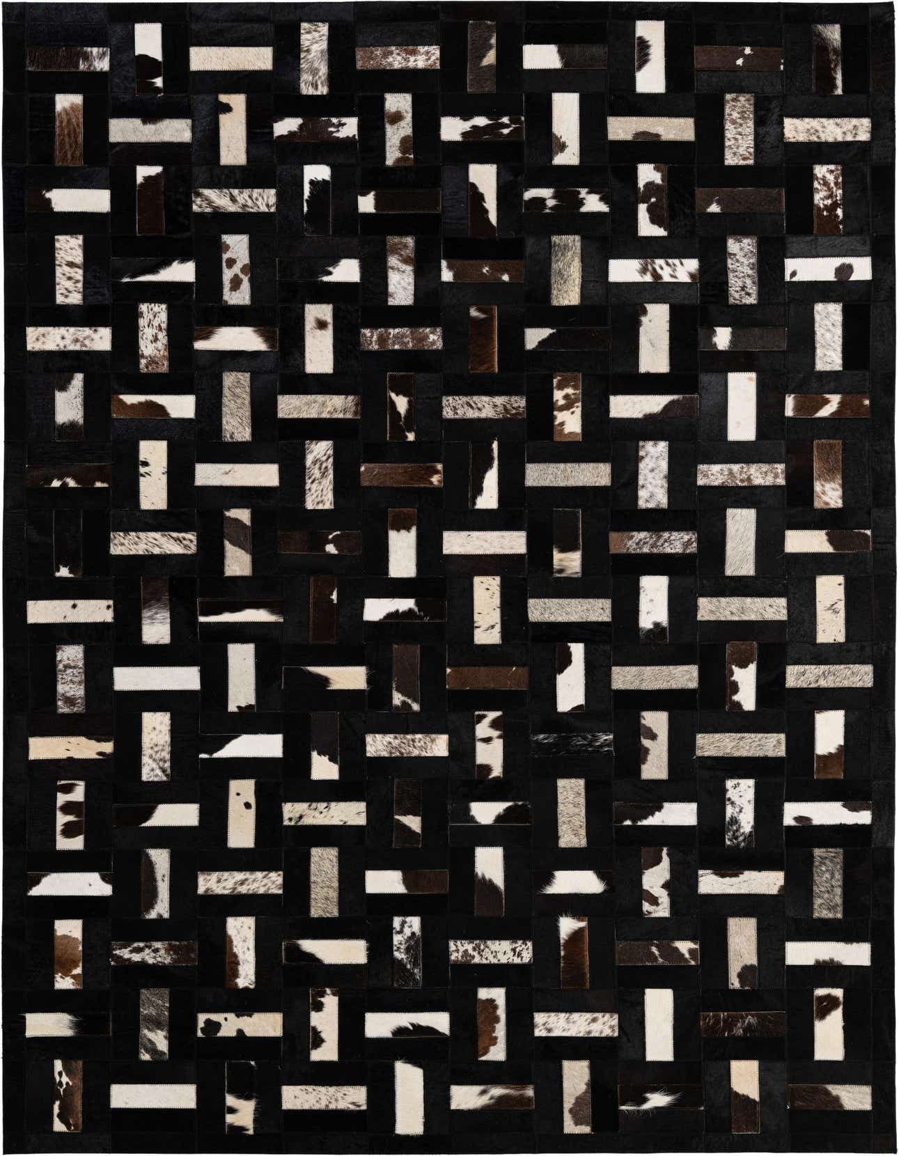 A 5x8 rectangular Cowhide - Patchwork rug featuring a modern stripe pattern of black, white, and brown cowhide patches.