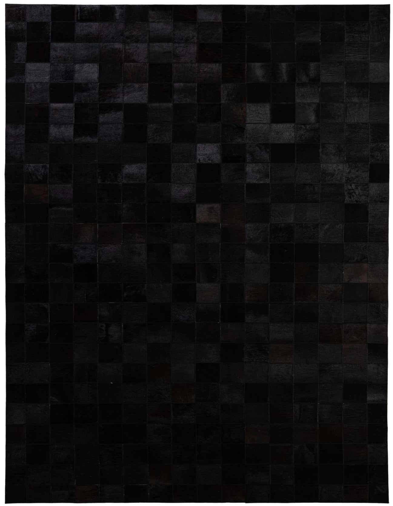 A 5x8 rectangular black modern cowhide rug with a patchwork pattern, perfect for a living room.