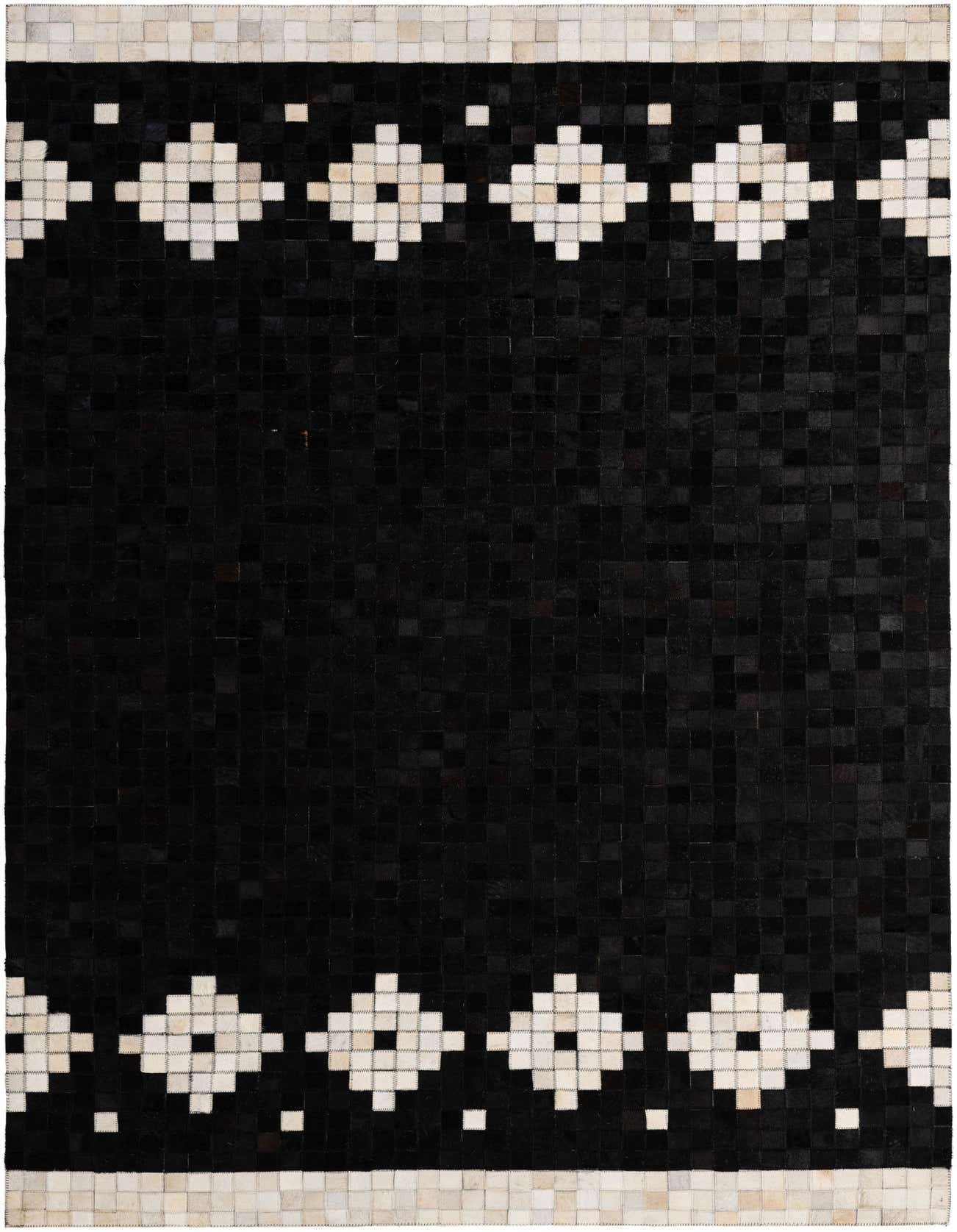 A 5x8 rectangular black cowhide rug with a modern geometric border of white squares and light brown patches.