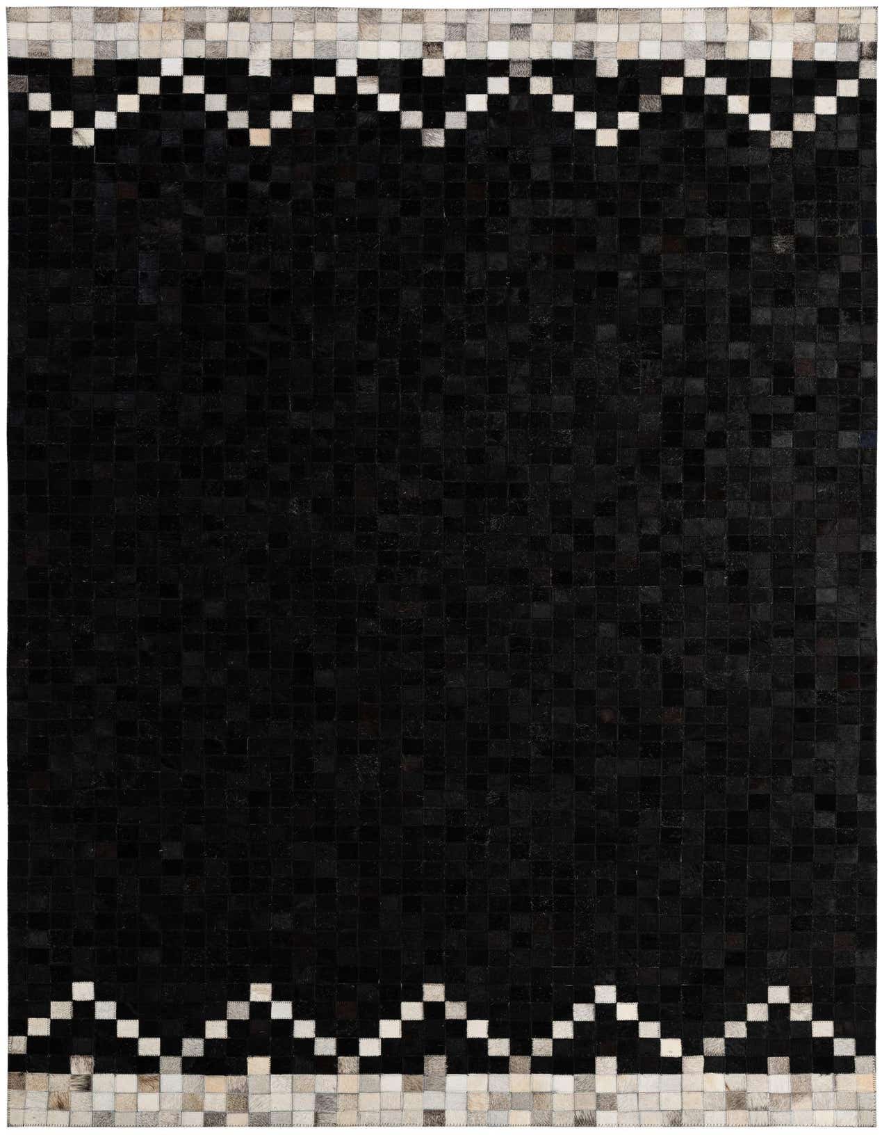 A 5x8 rectangular black cowhide rug with a modern patchwork design and a white and grey geometric border at the top and bottom.