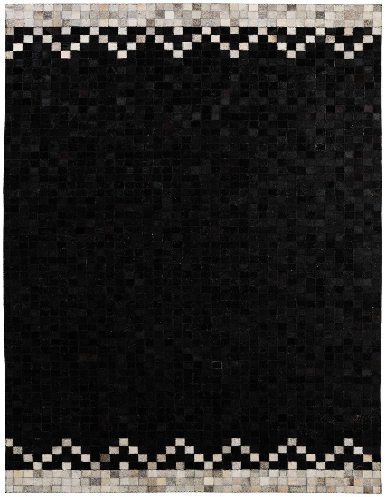 A 5x8 rectangular black cowhide rug with a modern patchwork design and a light grey and white geometric border on the top and bottom edges.