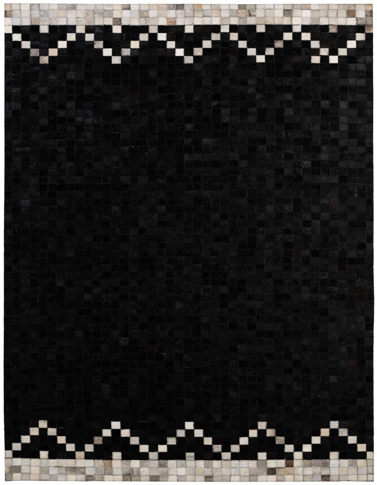 A 5x8 rectangular black cowhide rug with a modern patchwork design and a contrasting light gray and white geometric border.