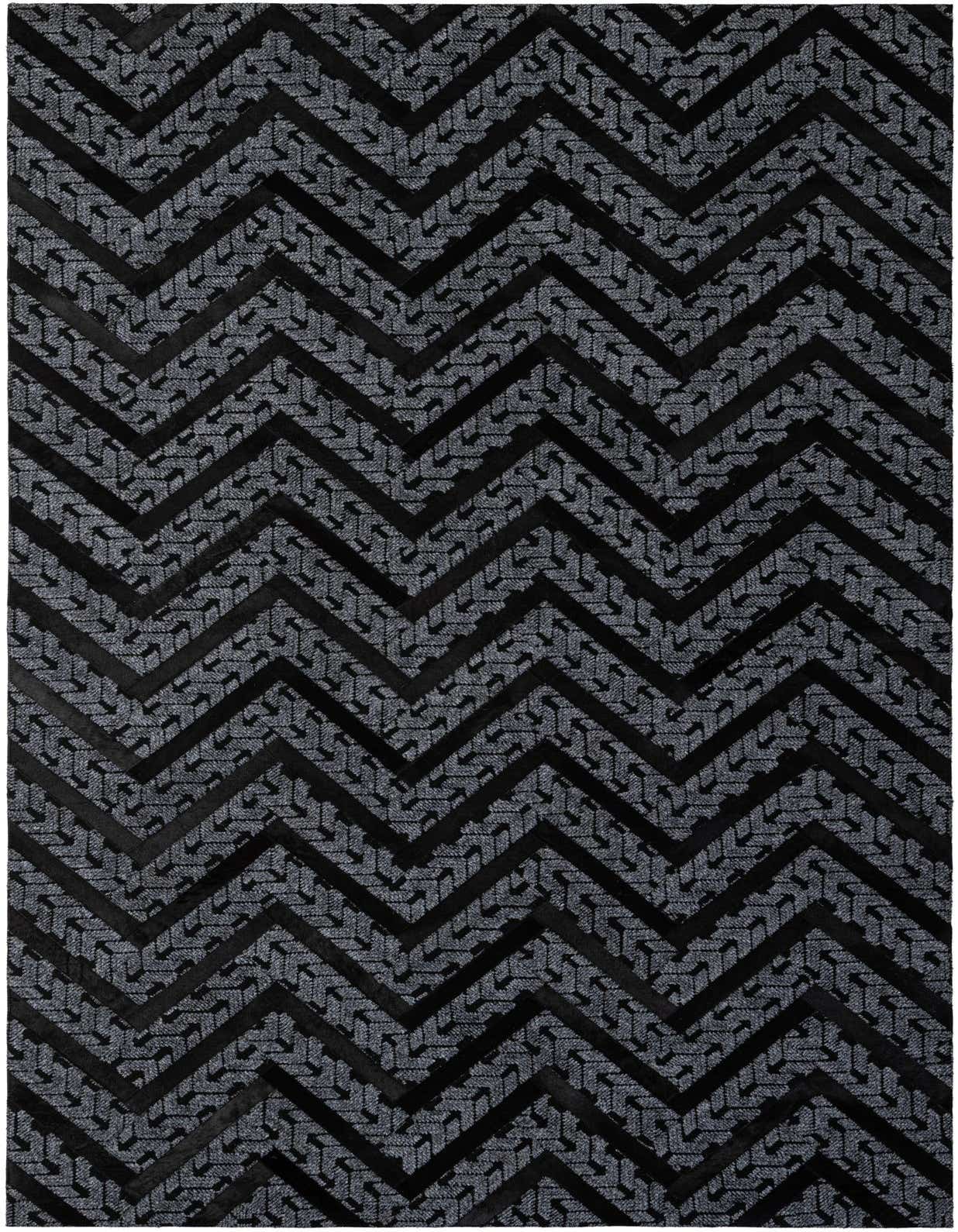 A 5x8 rectangular Cowhide - Patchwork rug featuring a bold black and dark grey modern chevron pattern, ideal for a living room.