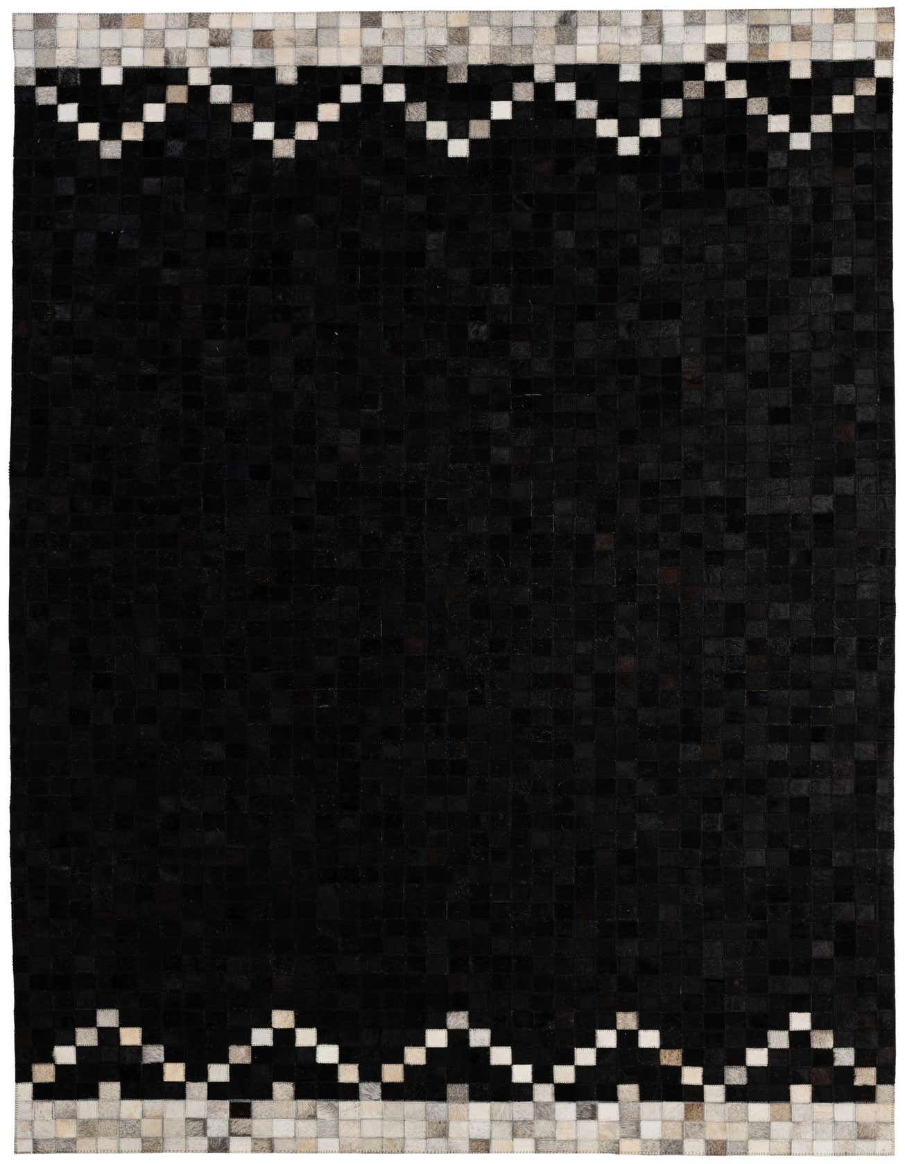 A 5x8 rectangular black cowhide rug with a modern patchwork design and a zigzag border of white and grey squares.