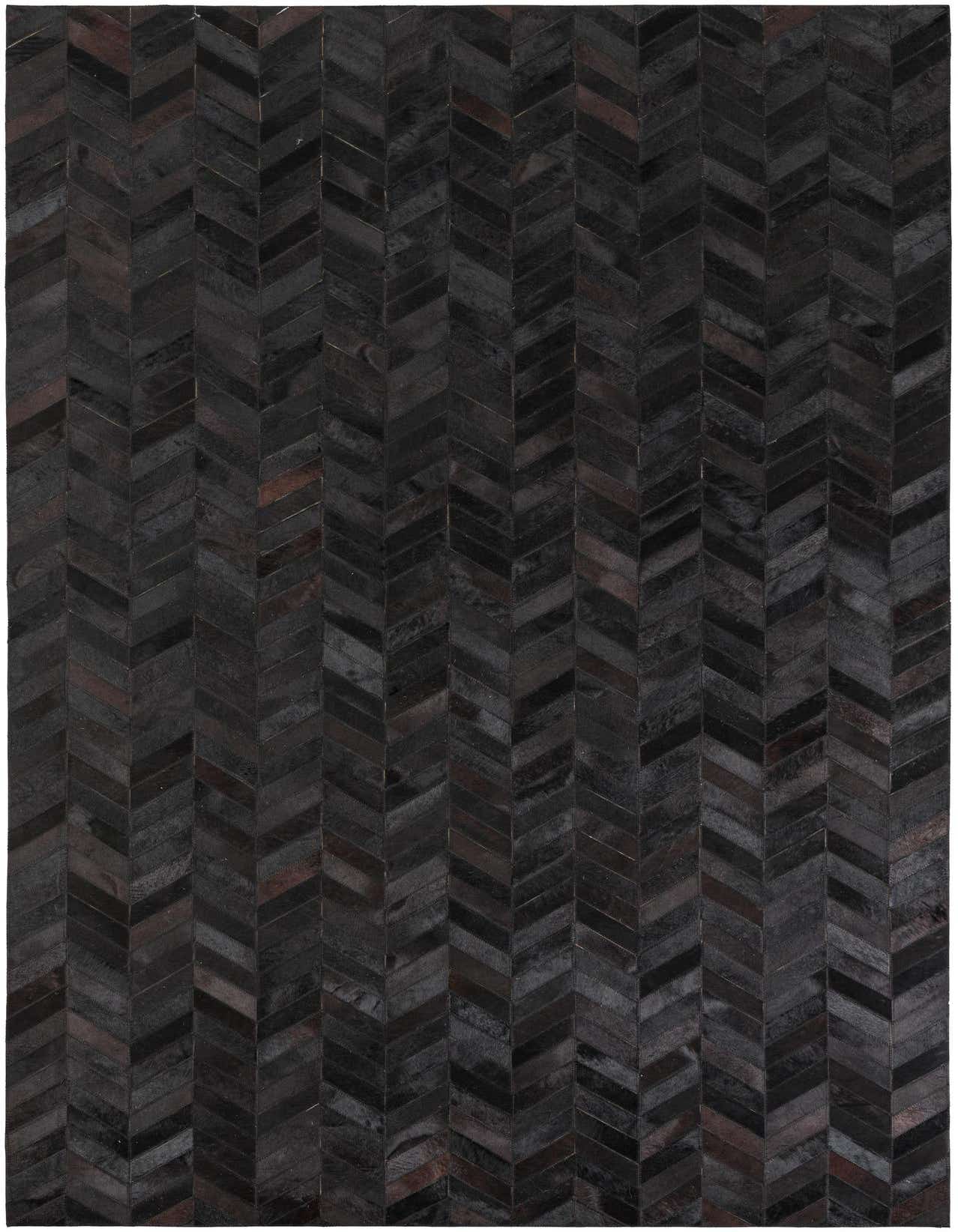 A 5x8 rectangular black cowhide leather rug with a modern chevron pattern, ideal for a living room.