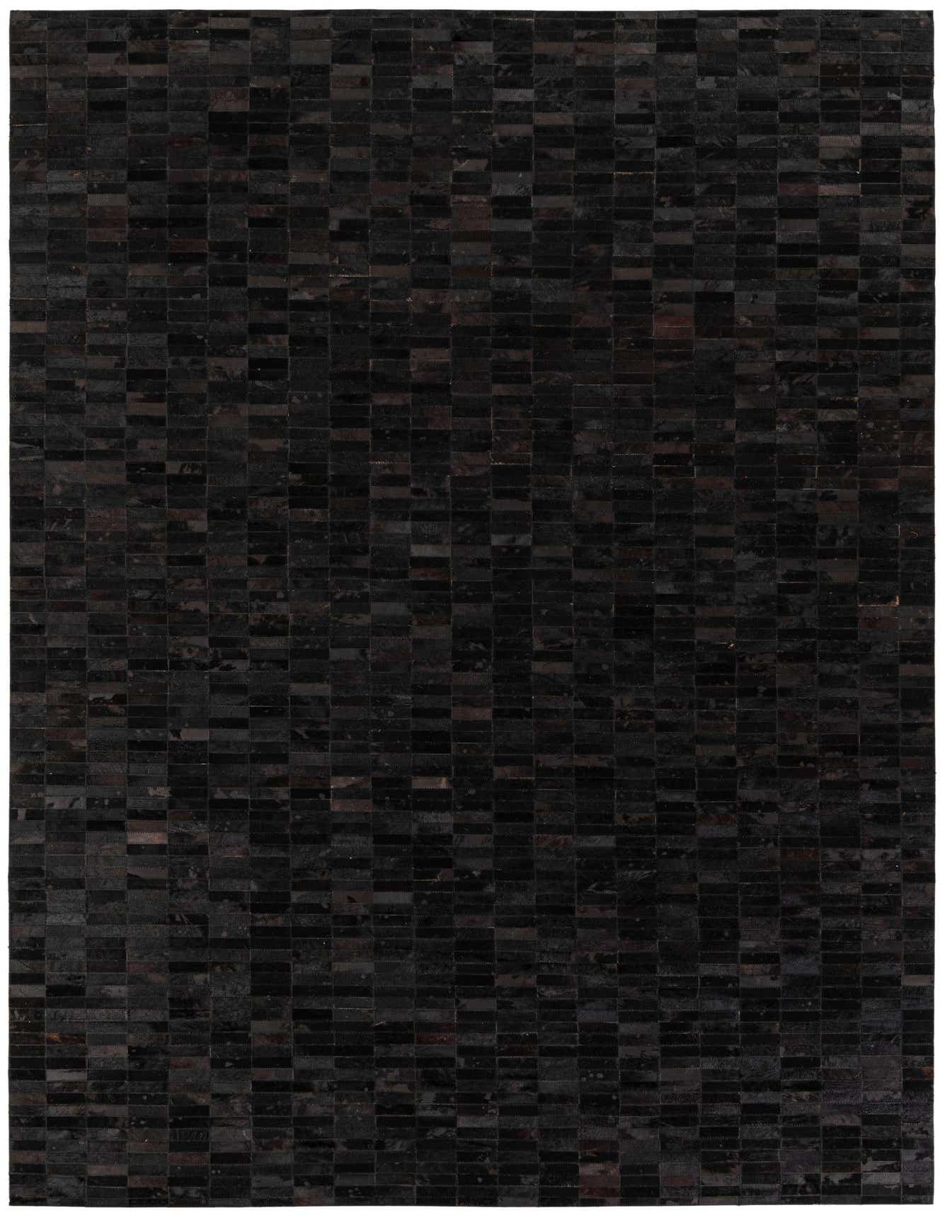A 6x9 rectangular black cowhide rug with a modern striped pattern, perfect for a living room or office.