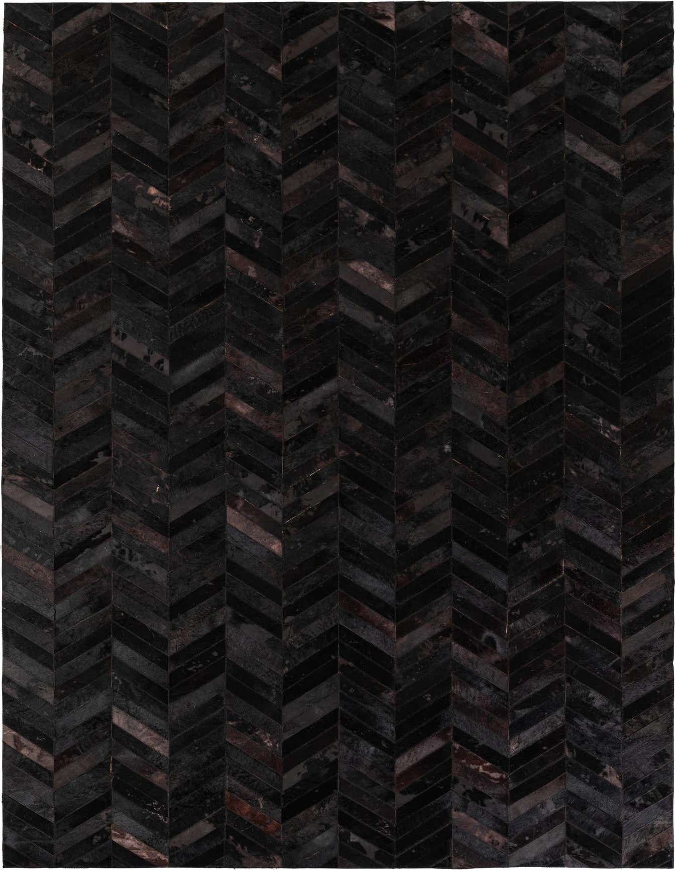 A 6x9 rectangular black cowhide rug with a modern chevron pattern, perfect for a living room.