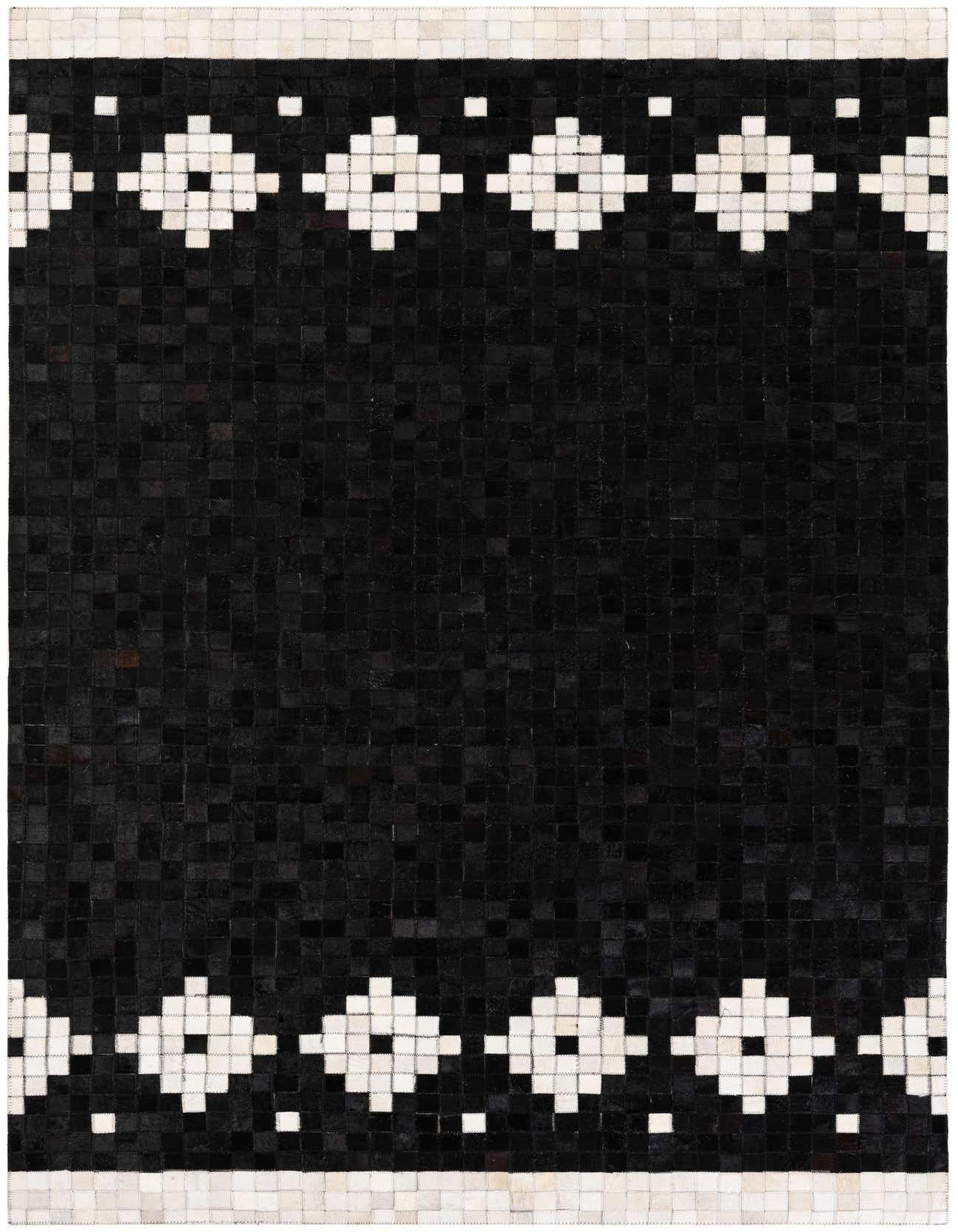 A 5x8 rectangular black cowhide rug with a modern geometric pattern of white diamond shapes and small squares along the top and bottom borders.