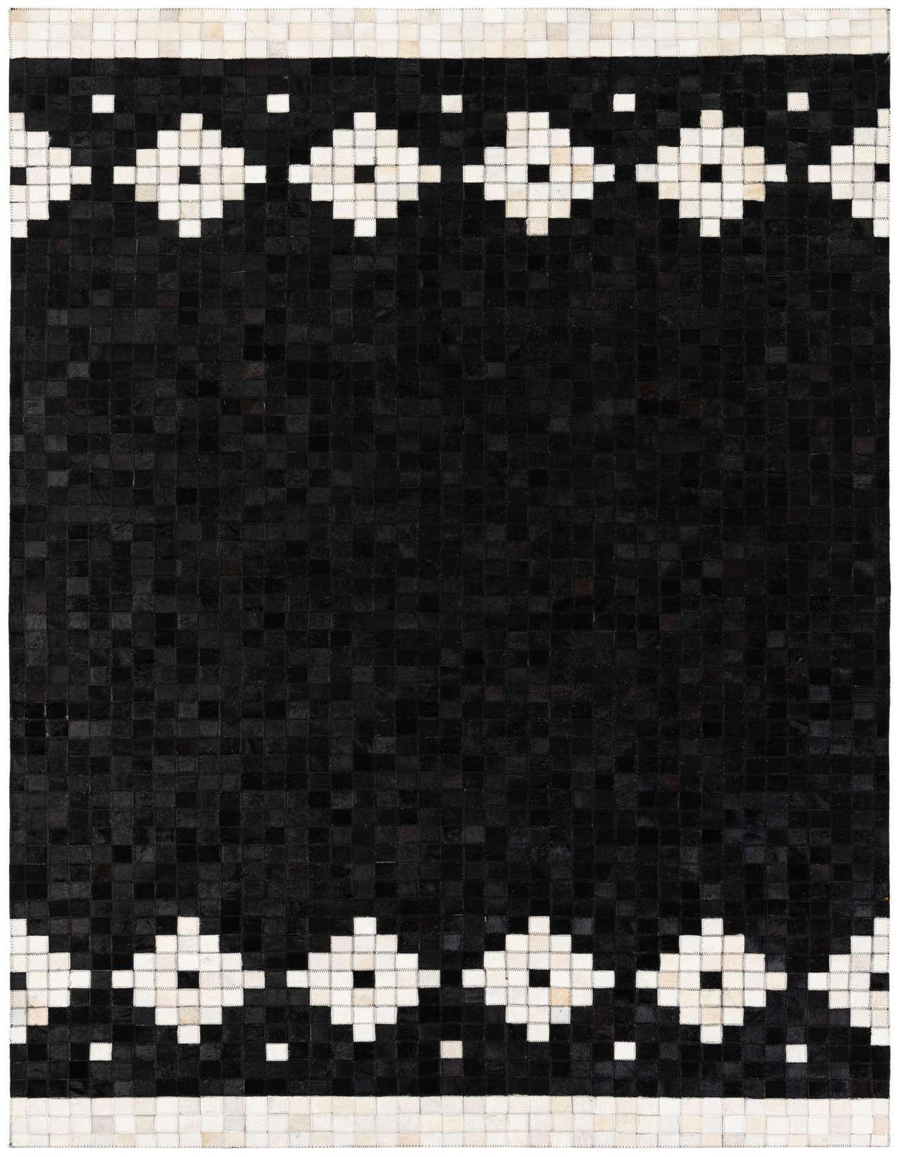 A 5x8 rectangular black cowhide rug with white geometric diamond patterns and borders, perfect for a modern living room.