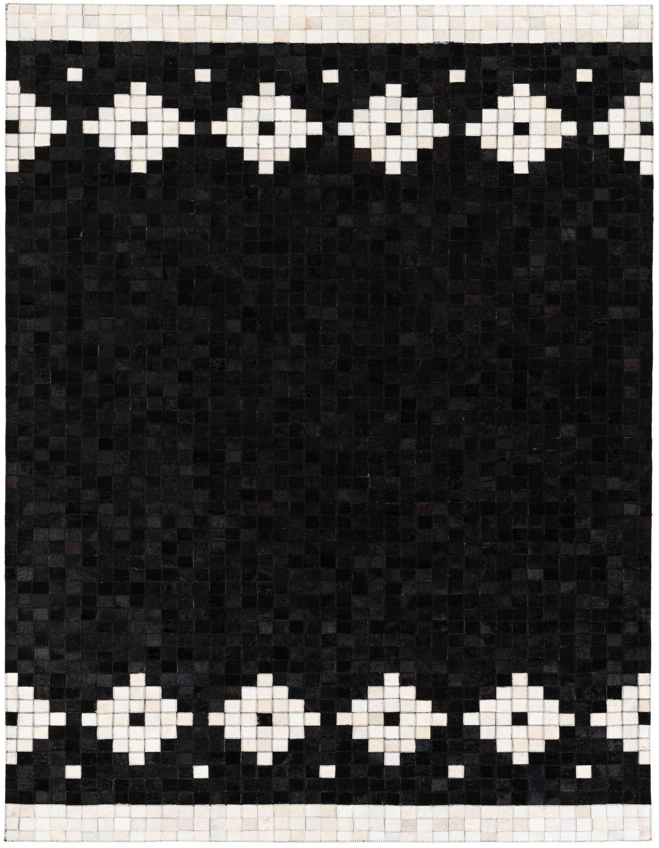 A 5x8 rectangular black cowhide rug with a modern geometric white diamond border pattern at the top and bottom.