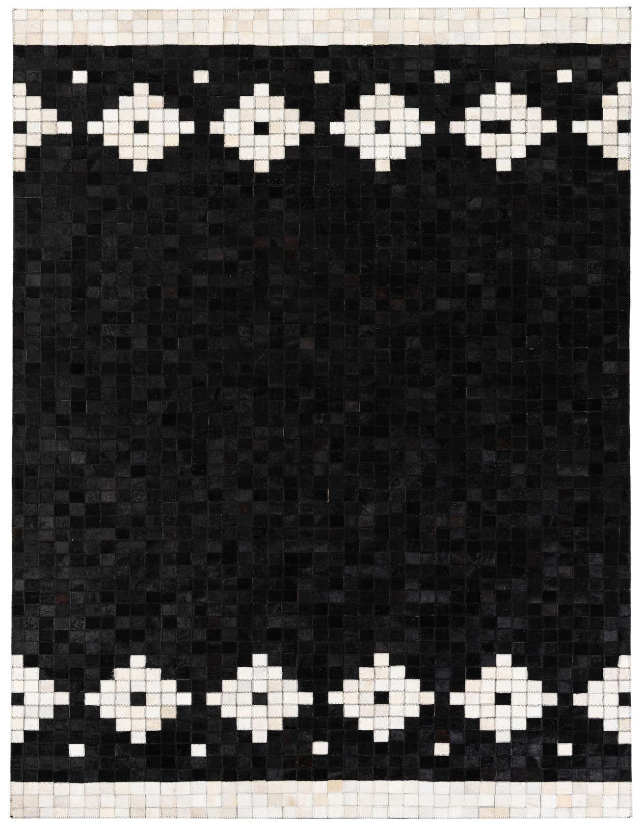 A 5x8 rectangular black cowhide rug with a modern geometric pattern of white diamonds and squares along the top and bottom borders.