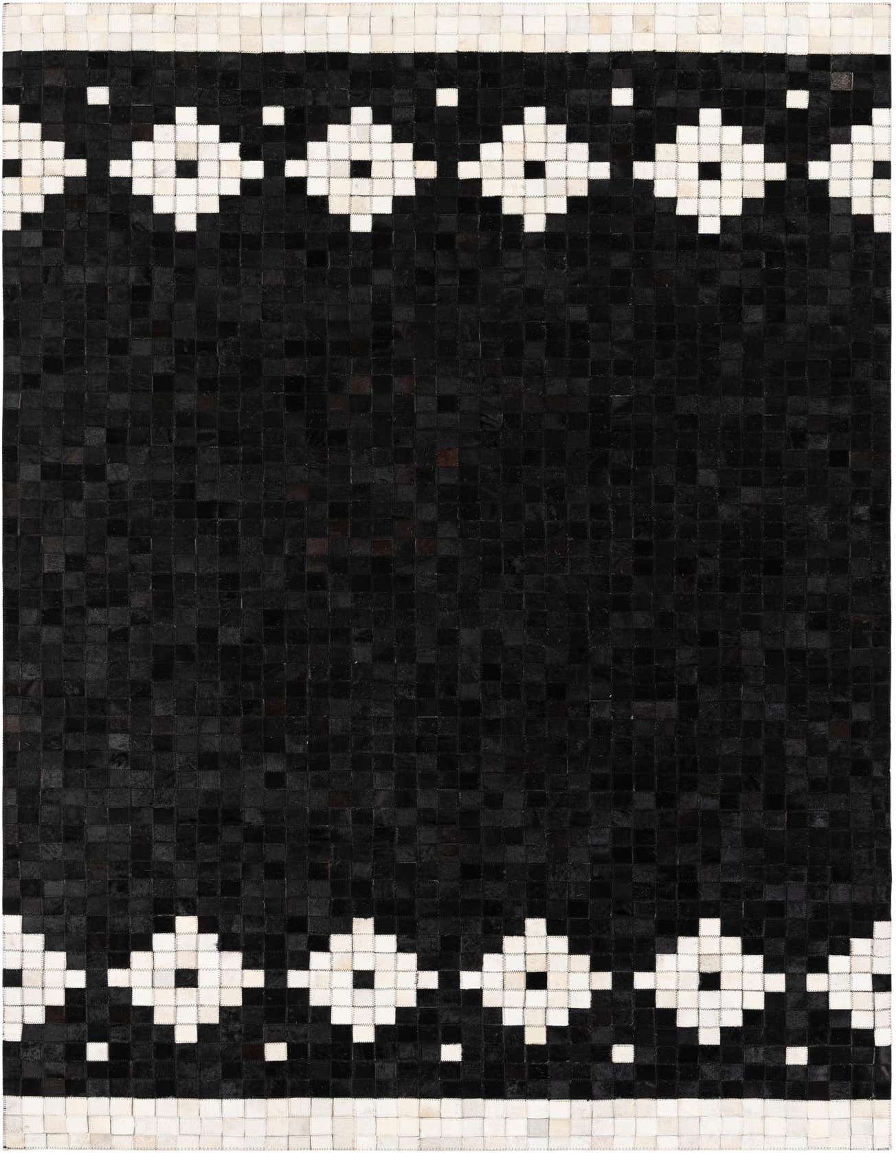 A 5x8 rectangular black patchwork cowhide rug with white geometric diamond and square borders at the top and bottom.