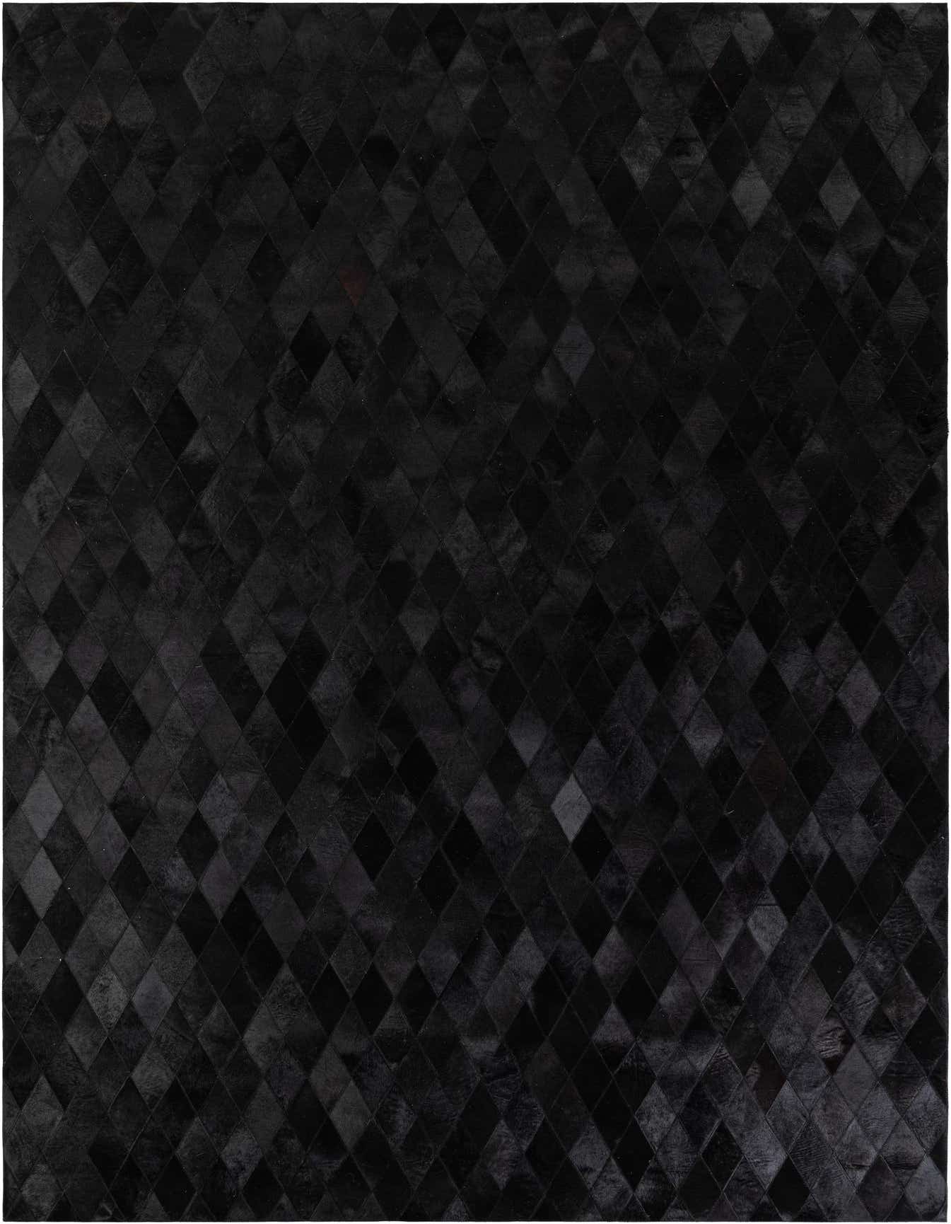 A 7x10 black rectangular patchwork cowhide rug with a geometric diamond pattern, suitable for a modern living room.