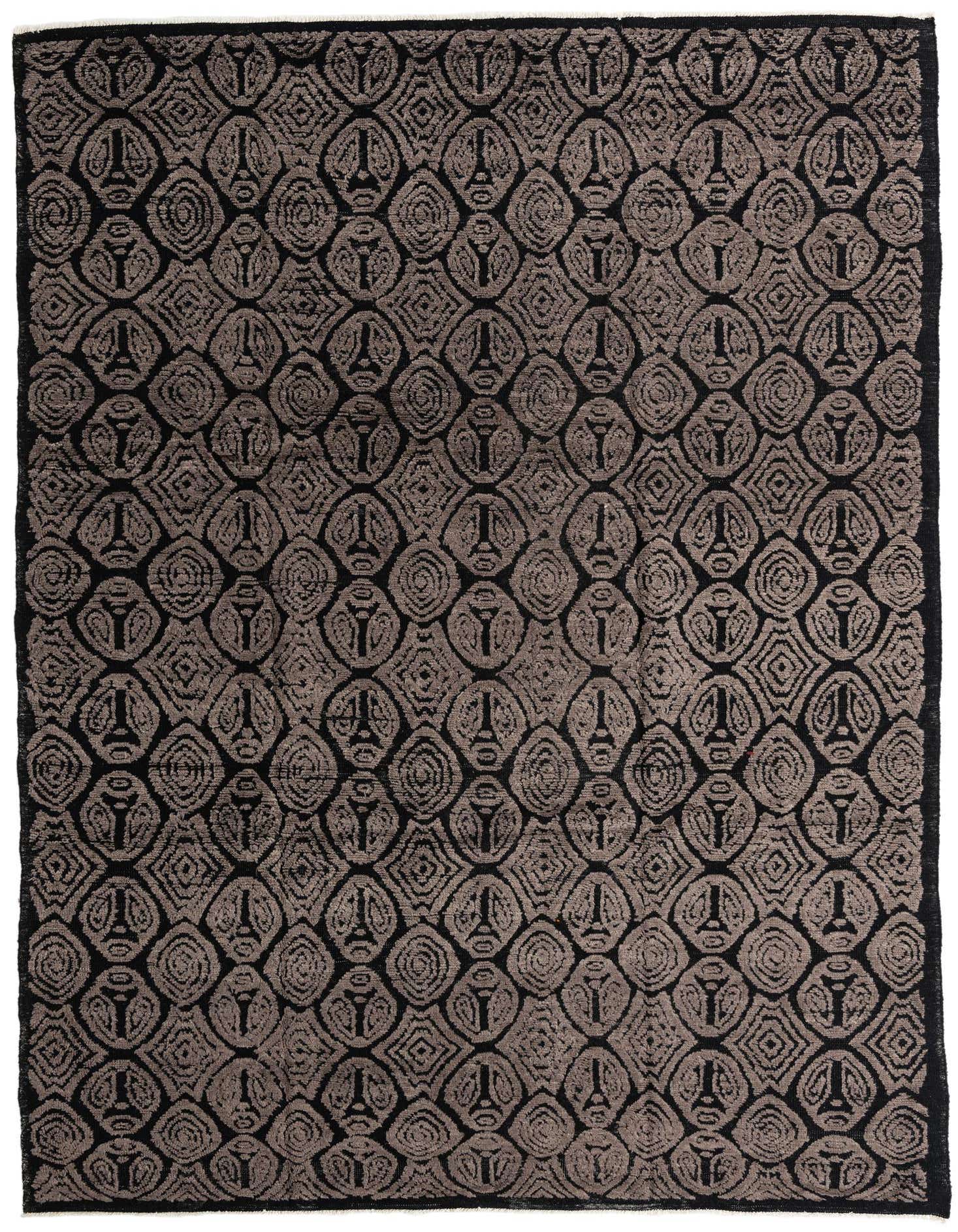 A 9x12 rectangular black wool rug with a high pile, featuring a repeating modern geometric pattern in varying shades of black and dark gray.