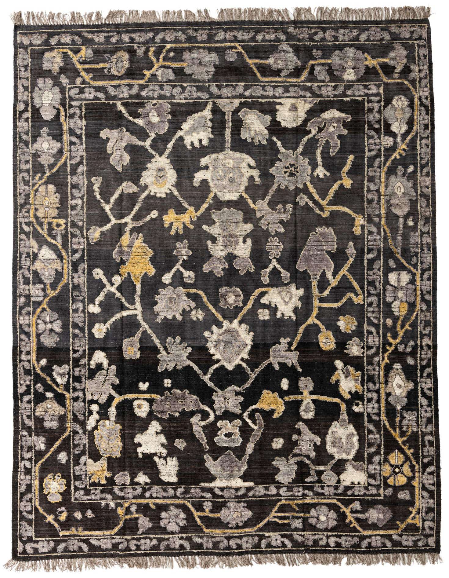 A 9x12 rectangular Darya Collection wool rug featuring an abstract floral pattern in black, gray, and gold, with fringed edges.