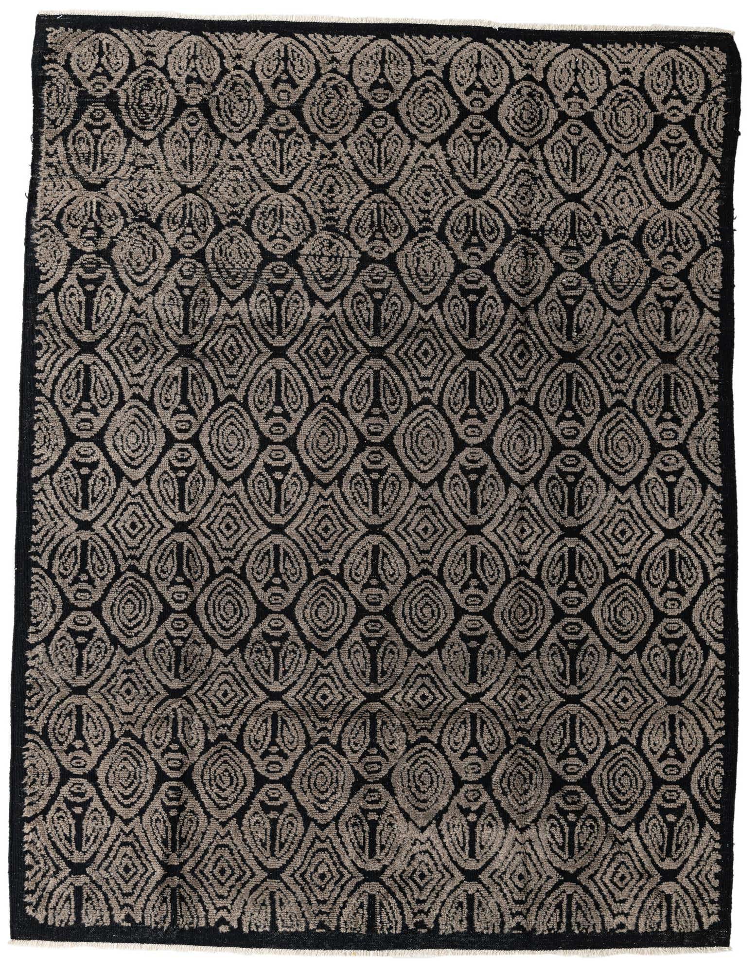 A rectangular 8x10 black wool rug featuring an abstract, modern pattern of interconnected dark gray shapes.