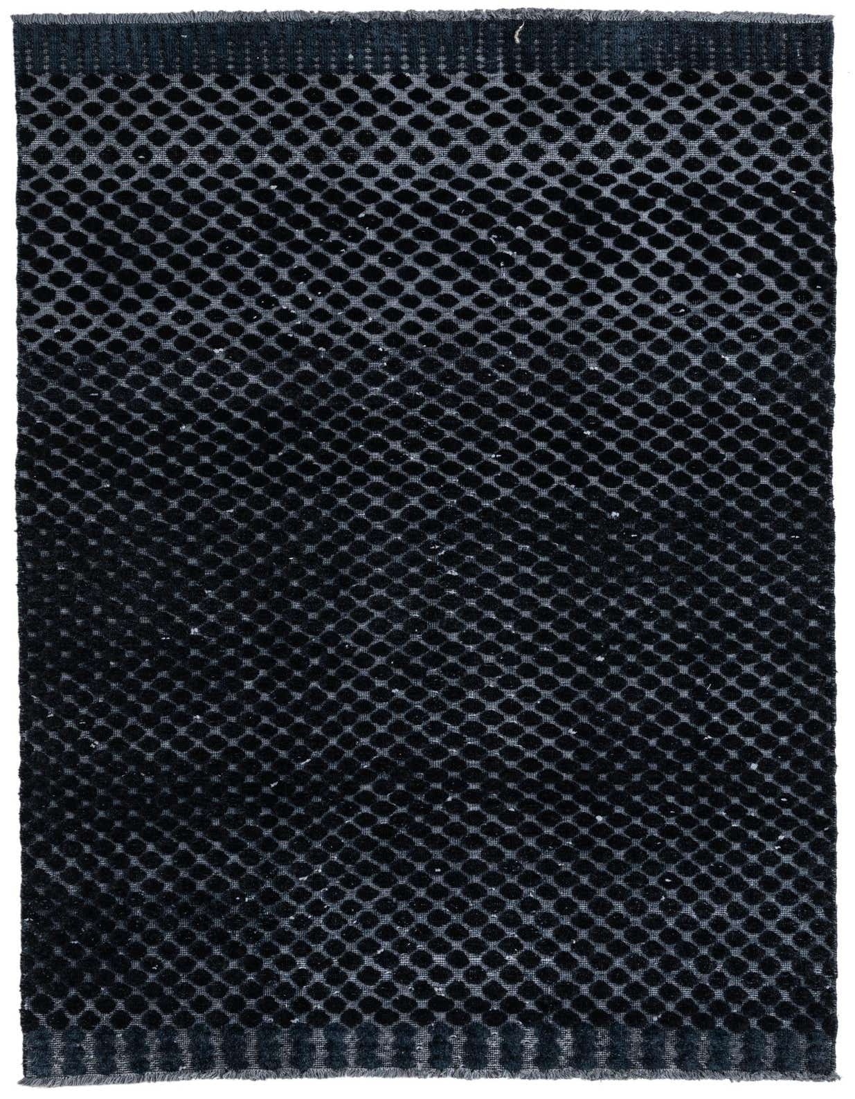 A 5x8 rectangular black wool rug with a modern textured dotted pattern, suitable for a living room.