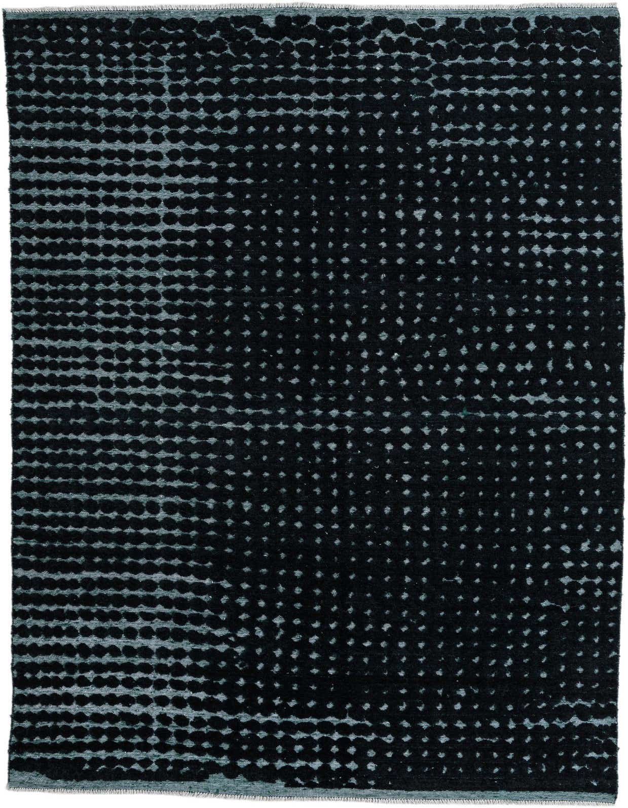 A 7x10 rectangular black wool rug with a modern abstract pattern of varying dot densities.