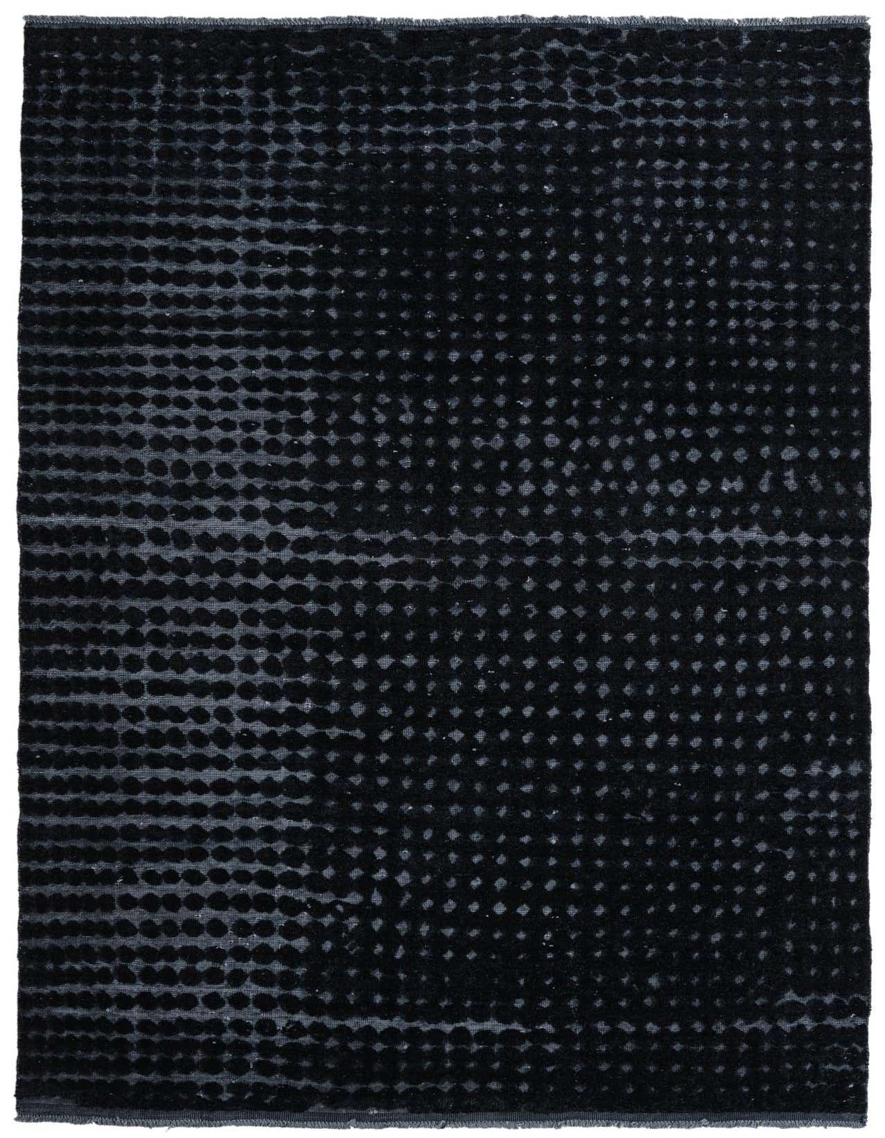 A 7x10 rectangular black wool rug with a modern abstract dotted pattern, suitable for a living room.