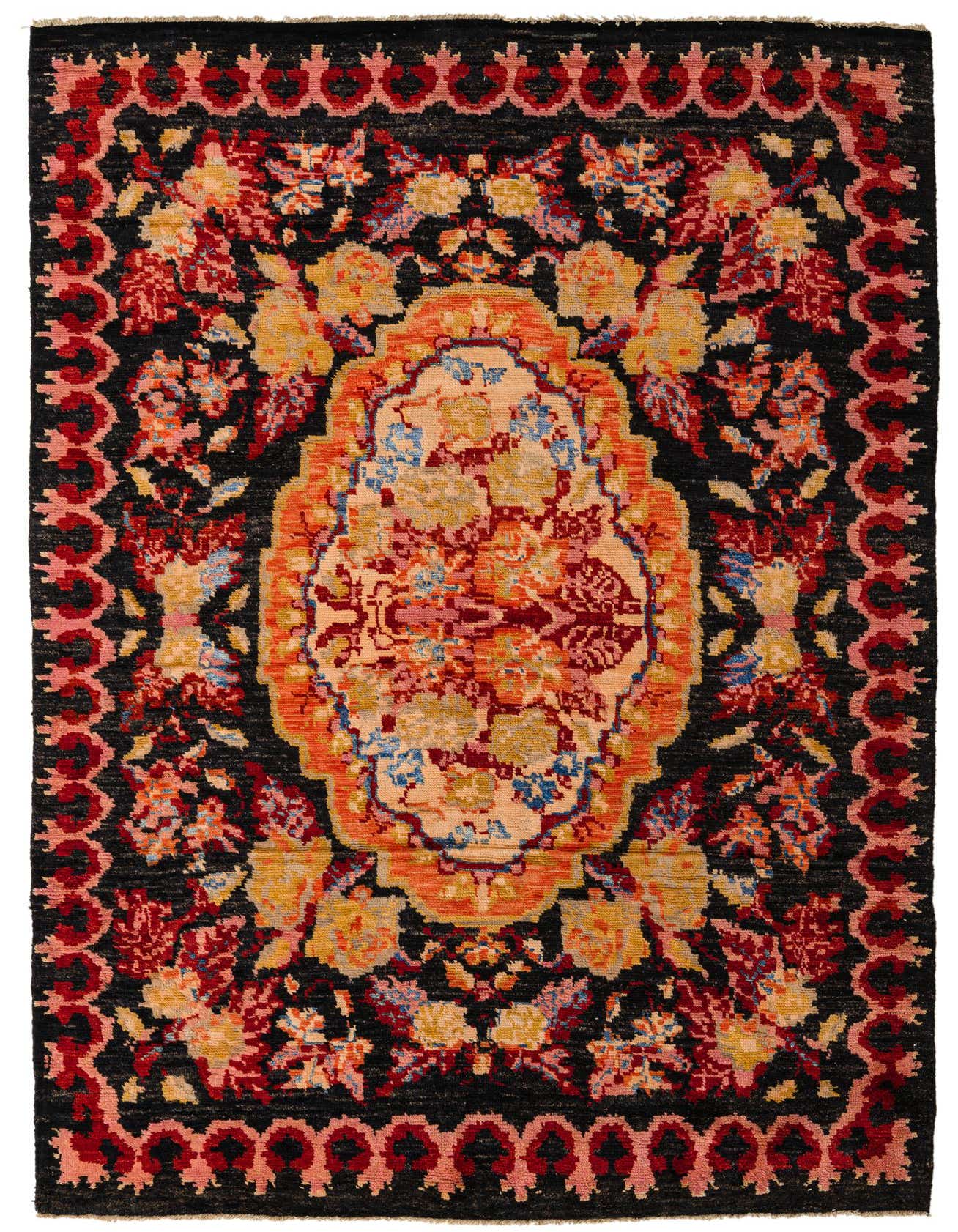 A 7x10 rectangular Darya rug with a black background, featuring a vibrant floral medallion in red, orange, yellow, and blue.