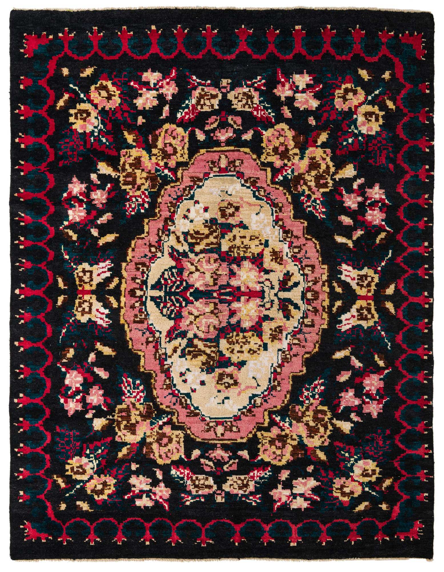 A rectangular 8x10 black wool rug with a central medallion, featuring traditional floral patterns in pink, red, and beige.