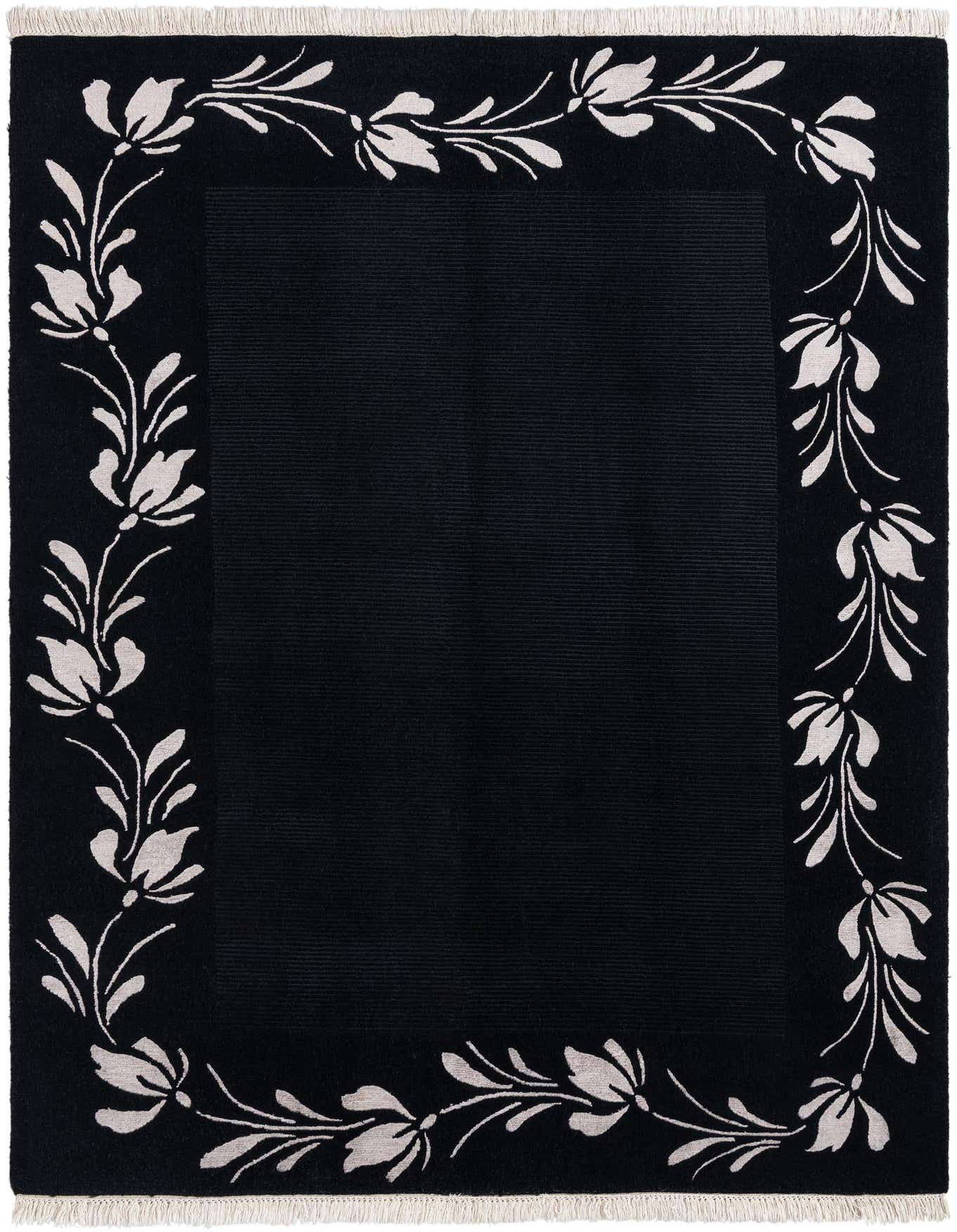 A 5x8 rectangular black area rug with an off-white floral border pattern and fringe, suitable for a living room.