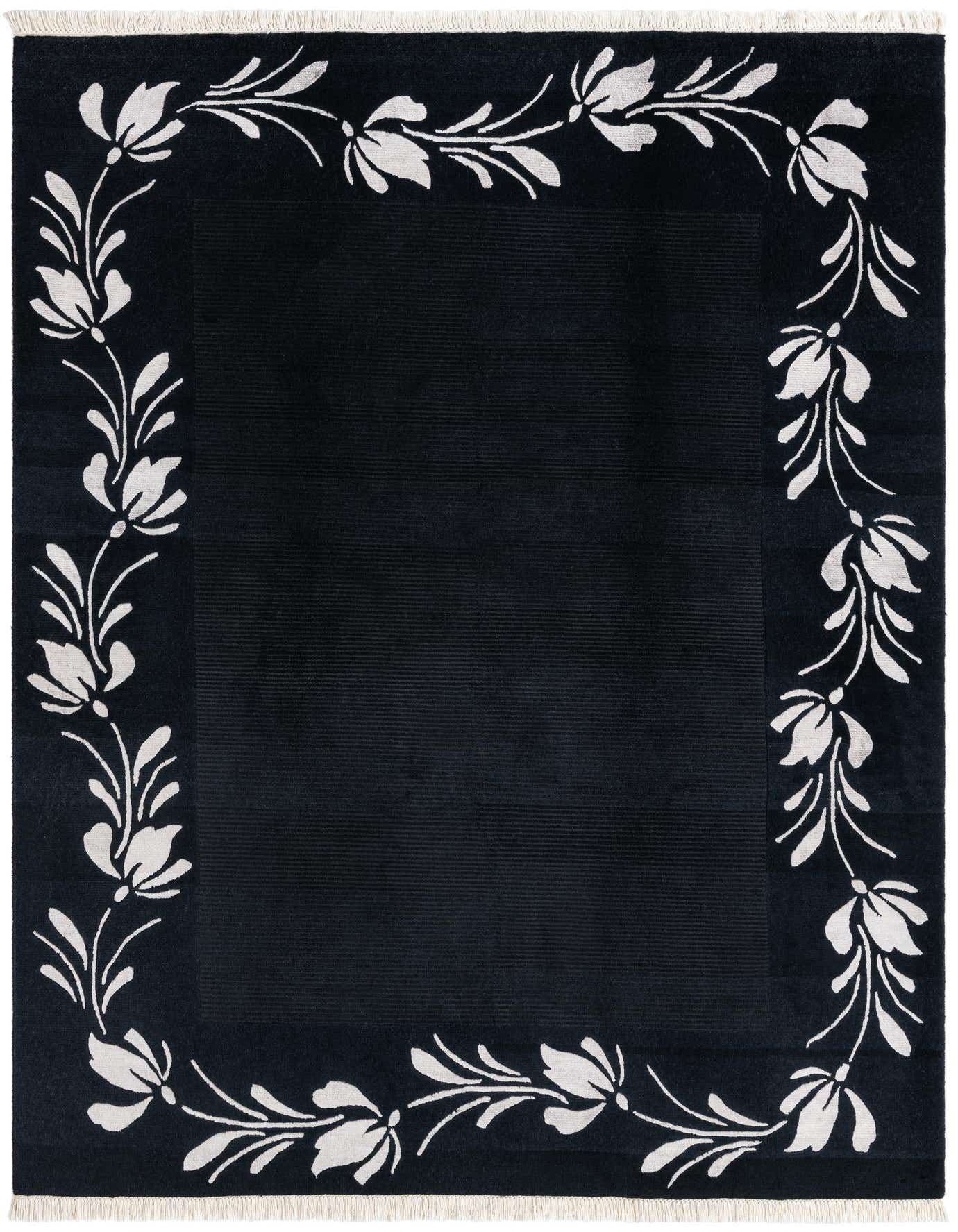A 5x8 rectangular black wool rug with a high pile and a white modern floral border pattern.