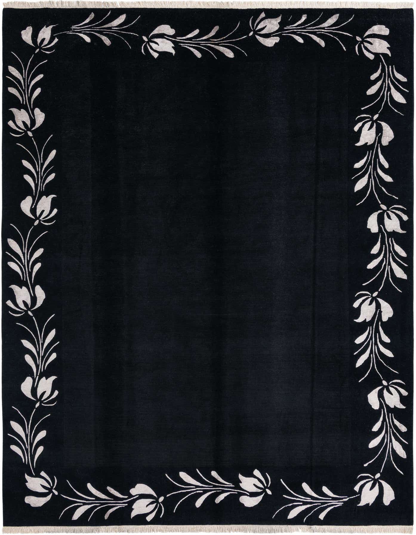 A luxurious 8x12 rectangular black wool rug featuring an elegant white floral border, perfect for a modern living room.