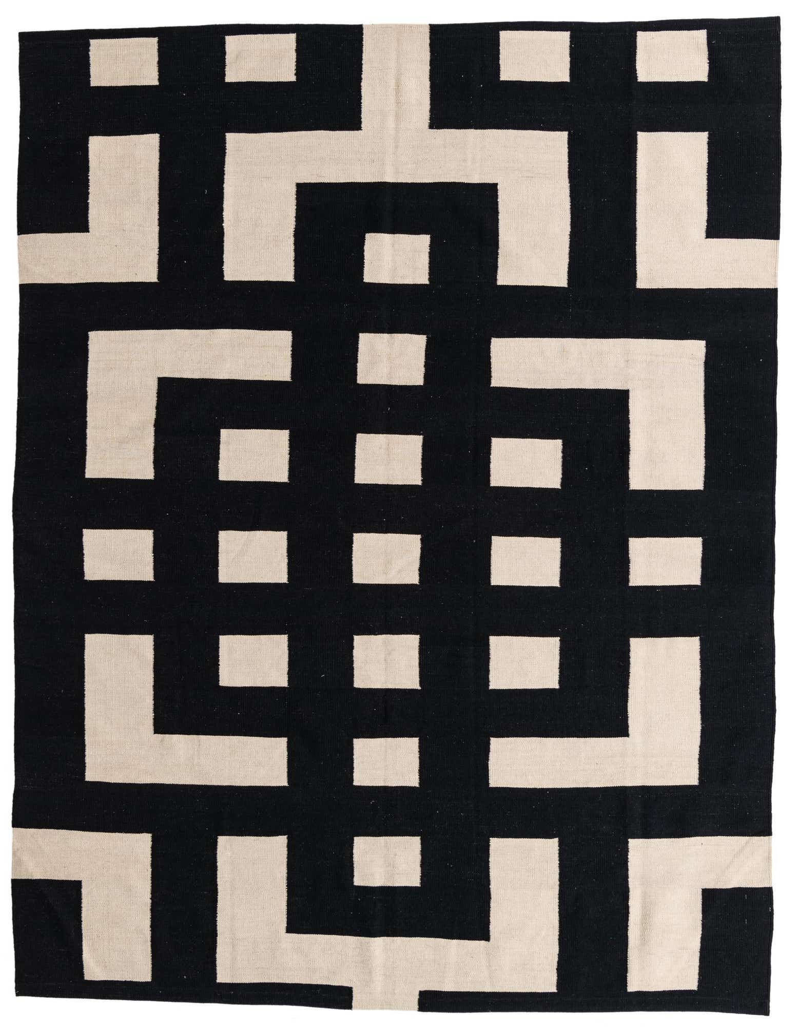 A rectangular 8x10 black and beige flatweave rug with a bold, interlocking geometric pattern, suitable for a modern living room.