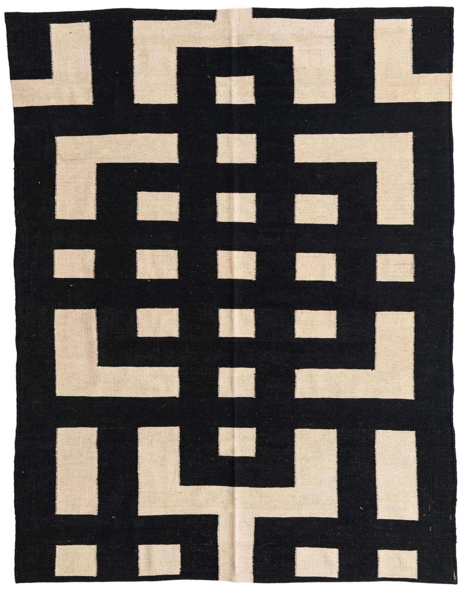 A 5x8 rectangular black and beige flatweave wool rug with a bold, interlocking geometric tribal pattern.