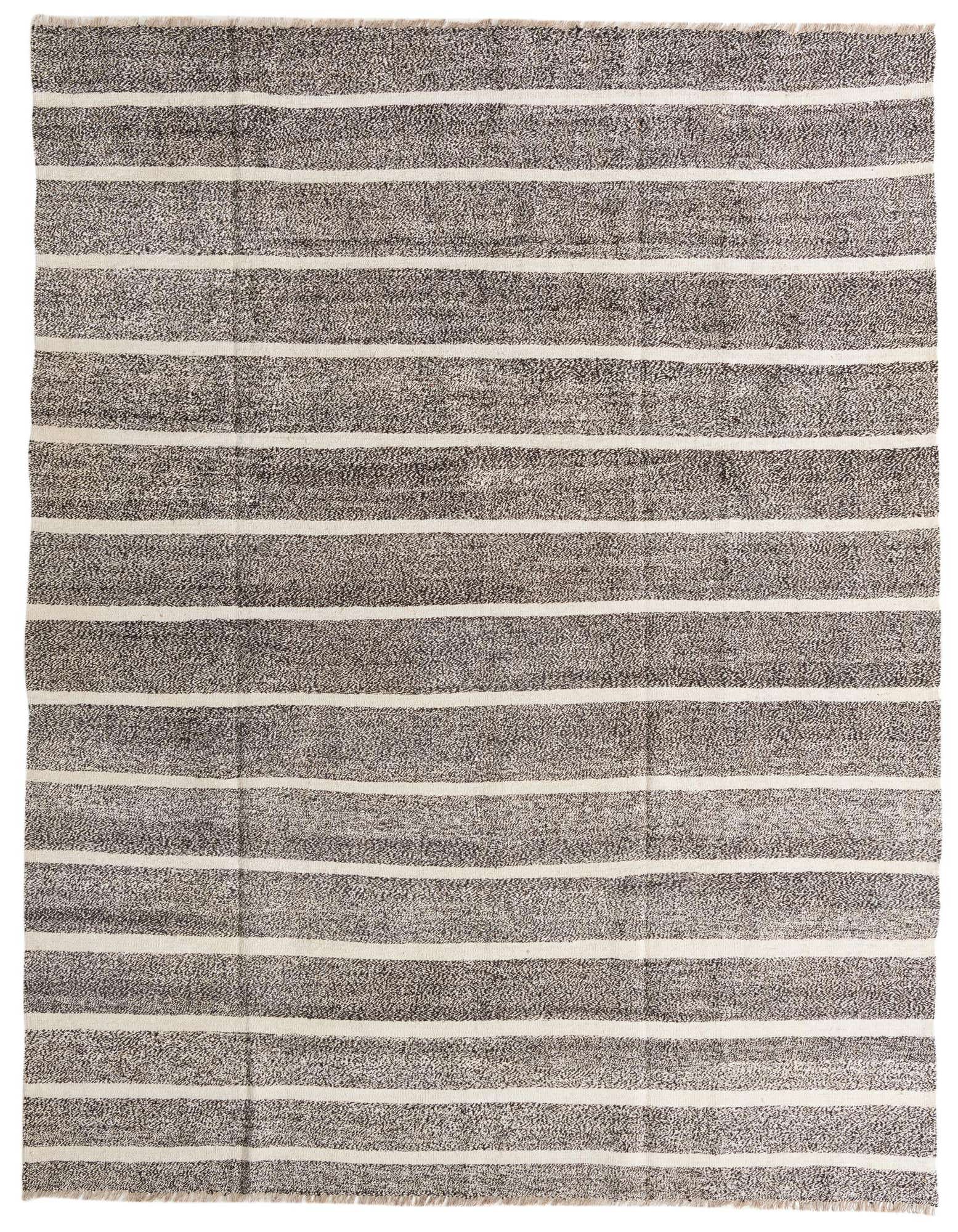 An 8x10 rectangular black and off-white striped flatweave wool rug with a modern tribal pattern.