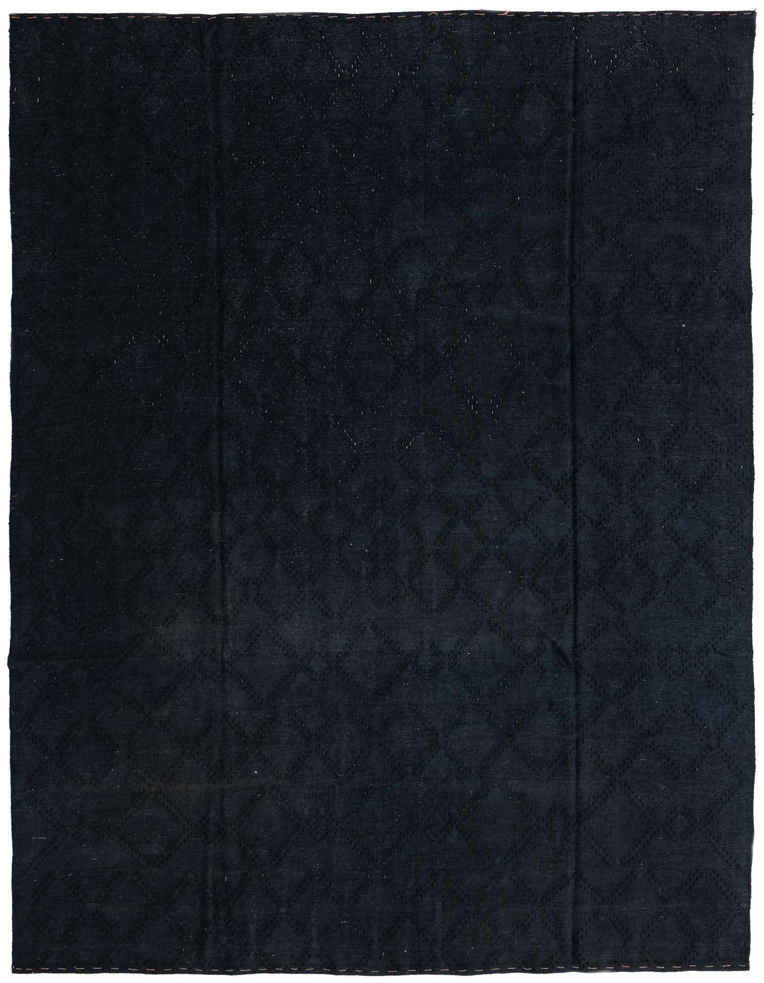 An 8x10 rectangular black wool flatweave rug with a subtle tribal geometric pattern, suitable for a living room.