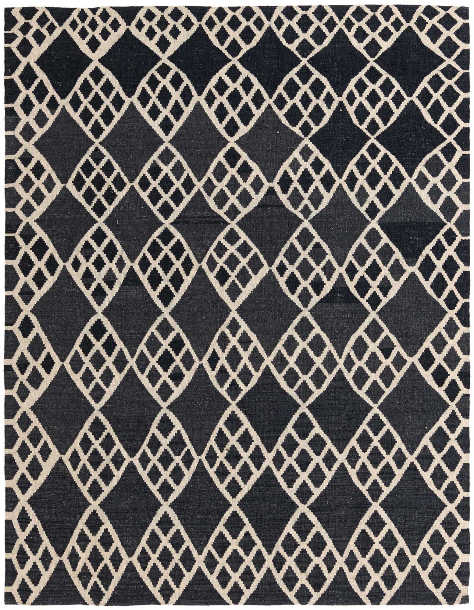 A 6x9 rectangular black wool rug with an intricate tribal diamond pattern in alternating dark and light tones.