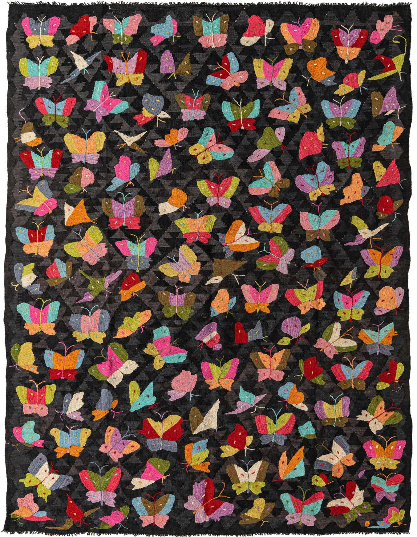 A 6x9 rectangular black flatweave rug featuring a vibrant, multicolored butterfly and geometric tribal pattern, ideal for a living room.