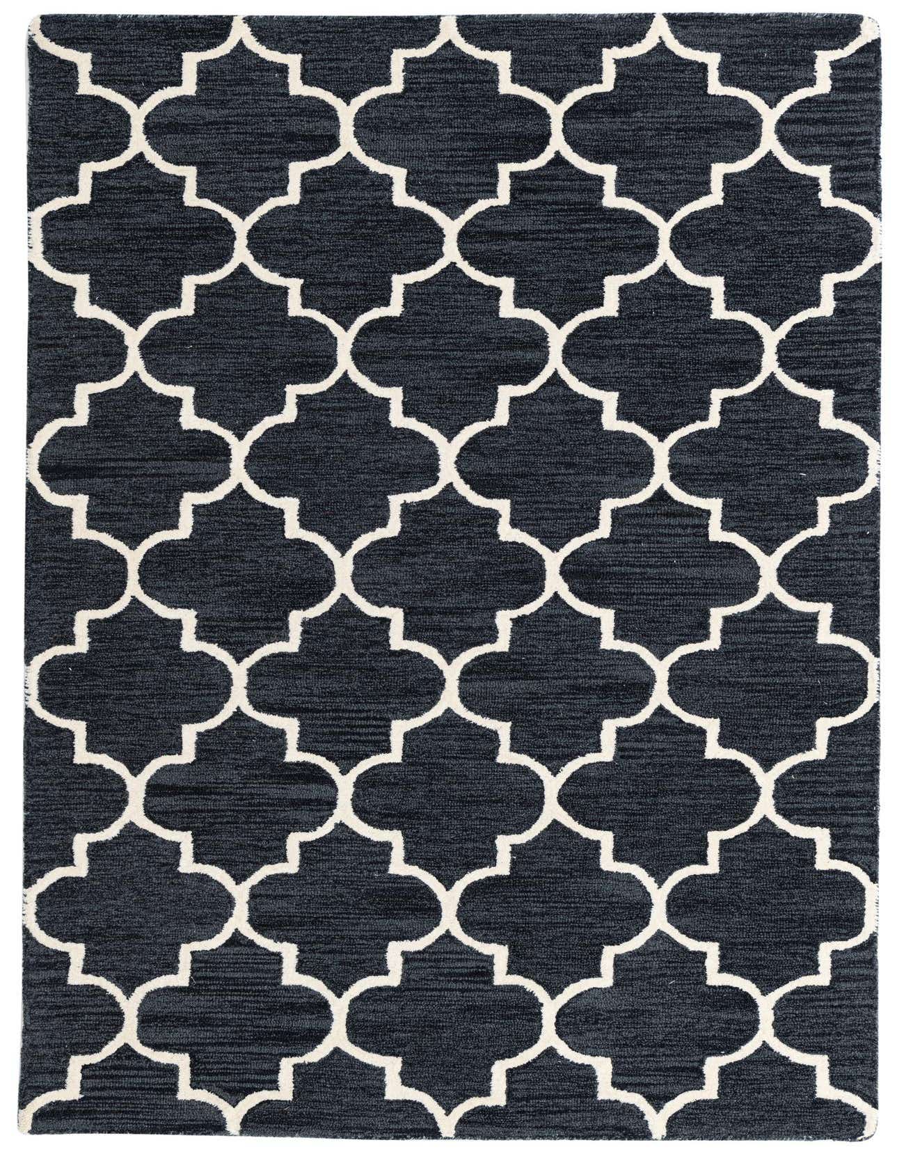 A 5x8 rectangular Luna Collection rug featuring a modern black background with a bold white quatrefoil pattern.