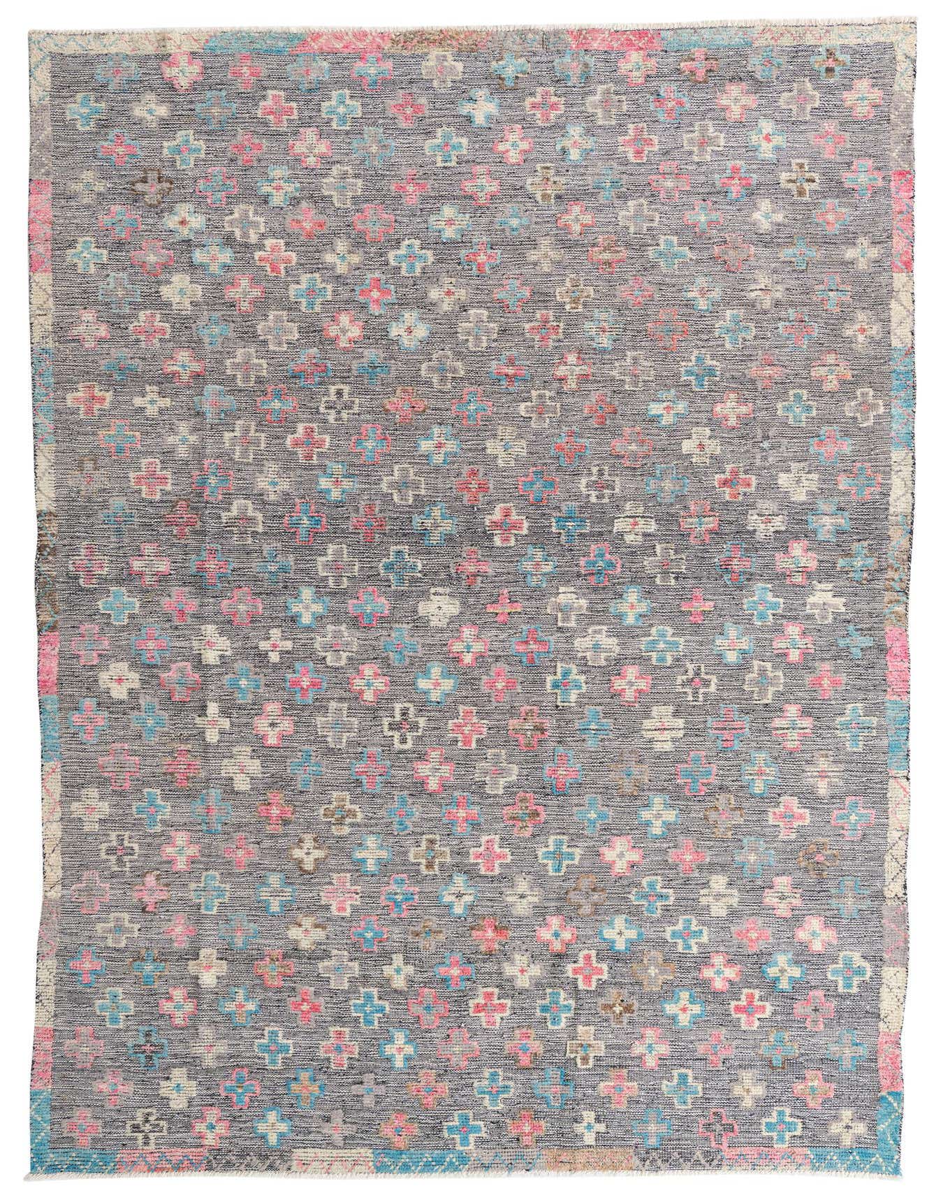 A 7x10 rectangular black wool rug with a repeating pattern of small, colorful Southwestern-style crosses in pink, blue, and white.