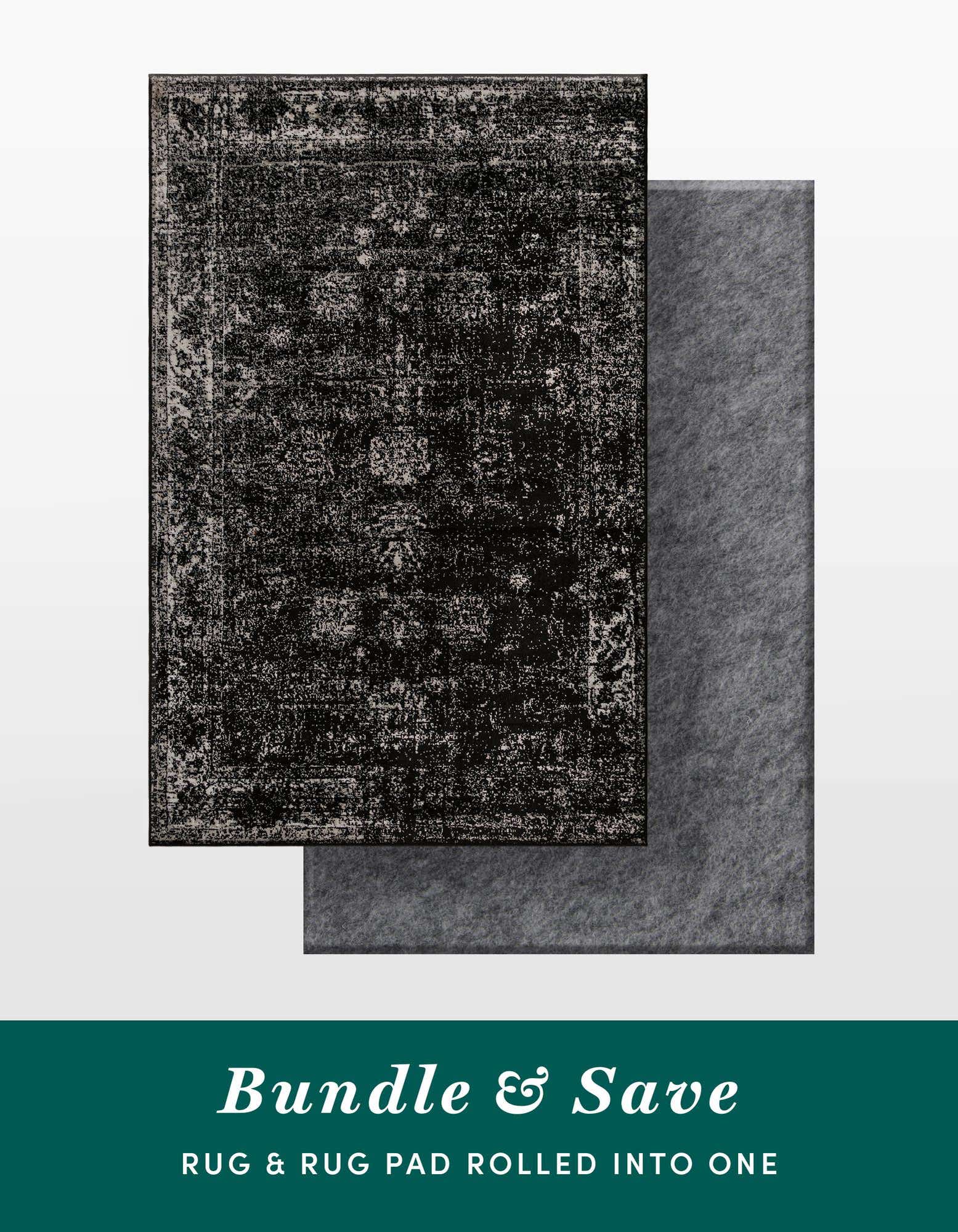A 5x8 rectangular Monte Carlo black vintage rug with a distressed pattern, paired with a gray rug pad underneath.