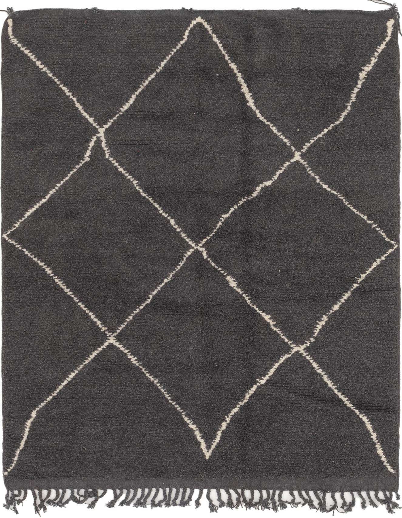 A 5x8 rectangular black shag rug with a cream tribal diamond pattern and fringe, perfect for a living room.