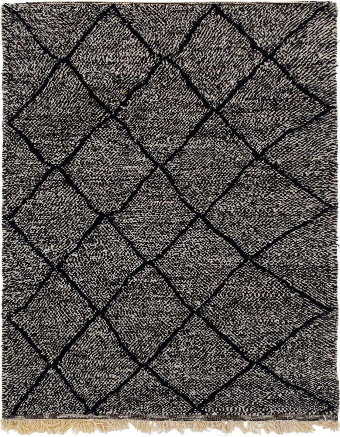 A 5x8 rectangular black and white shag rug with a tribal diamond pattern, featuring visible fringe.
