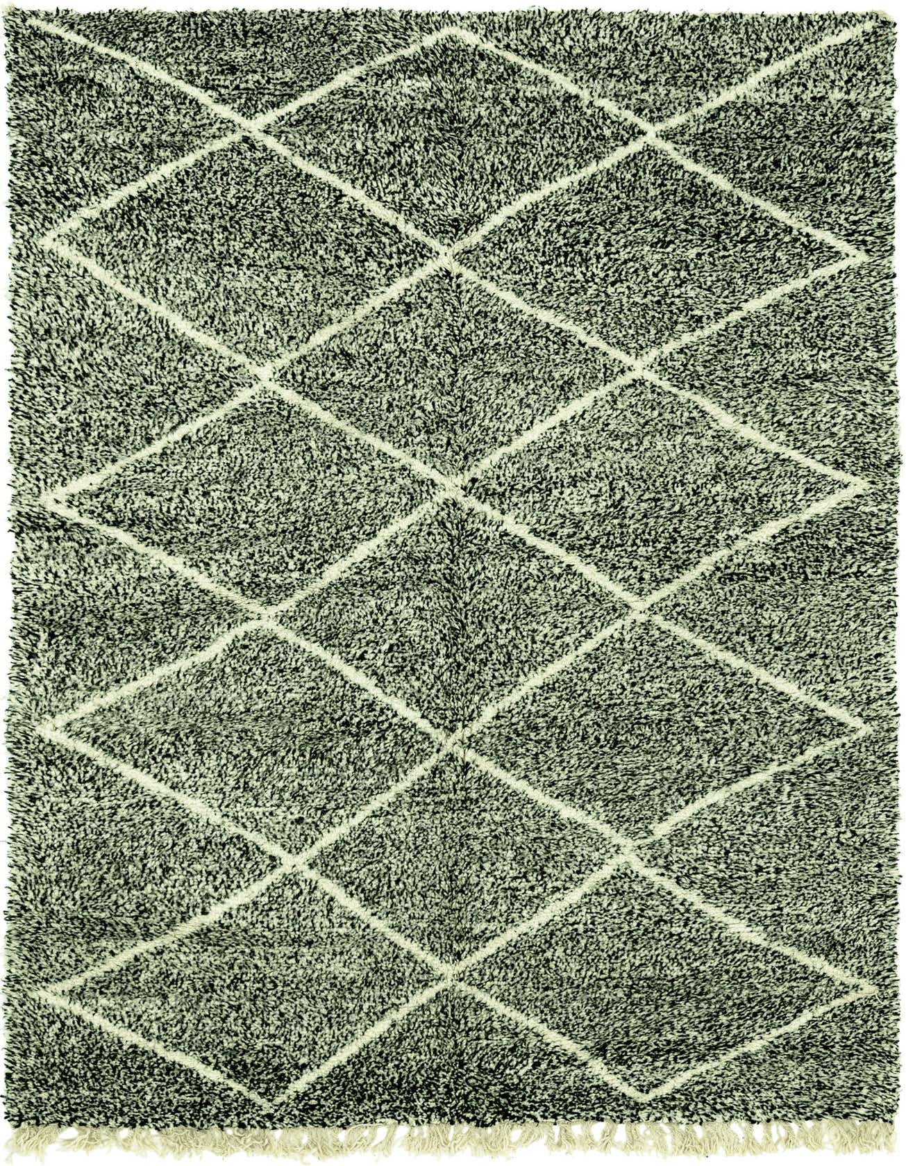 A 6x9 rectangular black shag rug with a white tribal diamond pattern and fringe, perfect for a modern living room.