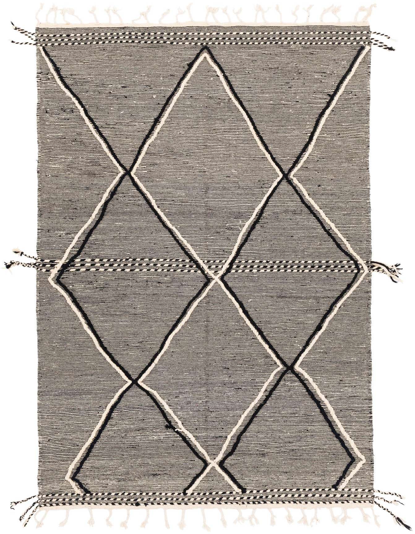 A 6x9 rectangular black wool shag rug with a bold tribal diamond pattern in black and off-white, featuring decorative tassels.